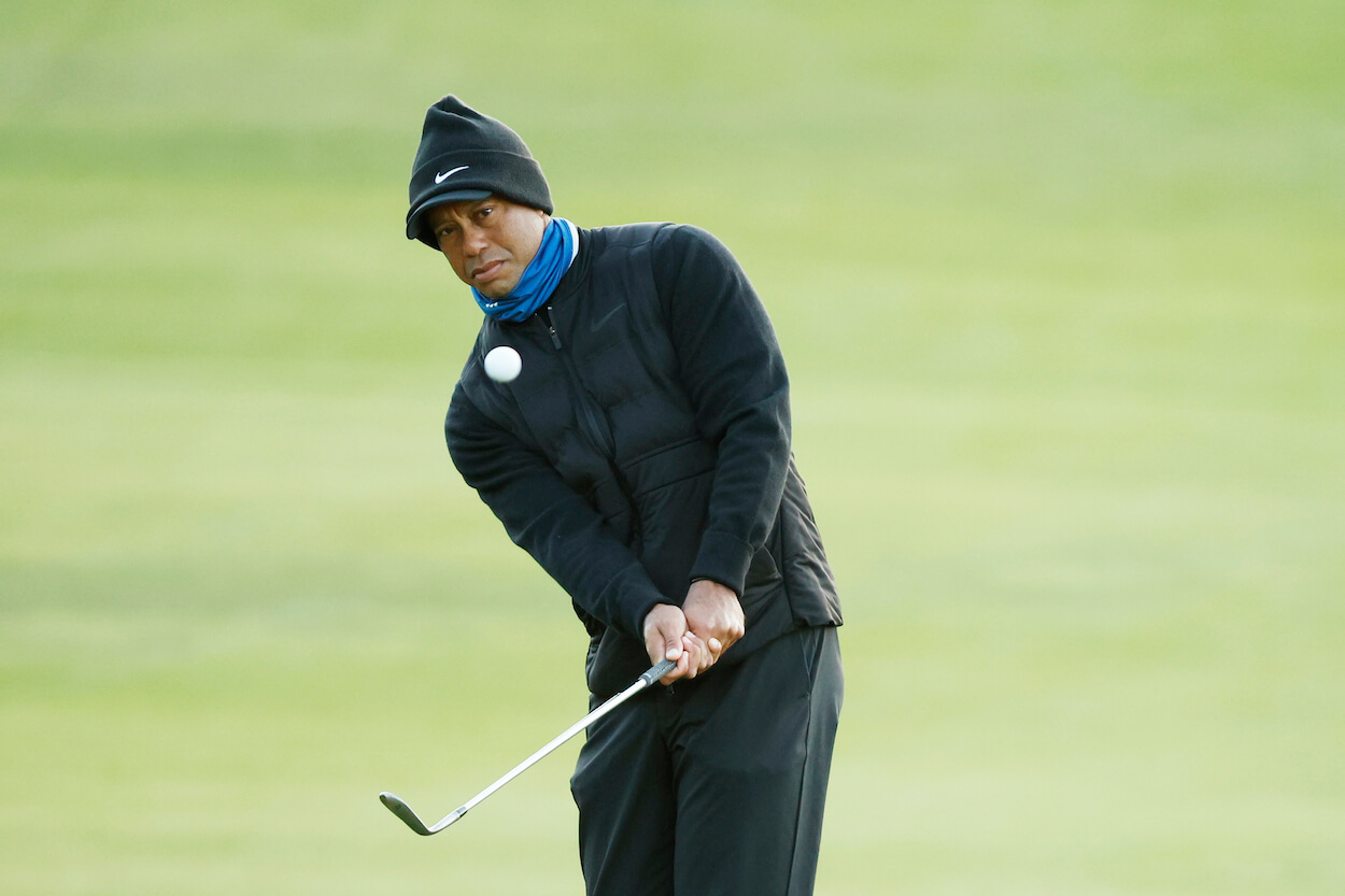 Tiger Woods plays a chip at Riviera Country Club.