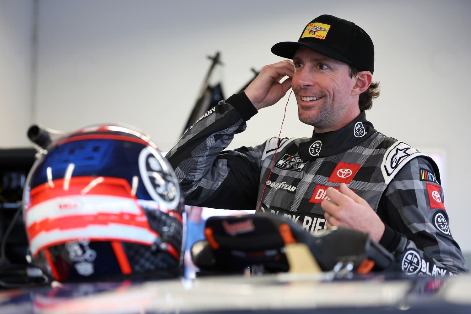 Travis Pastrana prepares in the garage area during practice for the NASCAR Cup Series Daytona 500 at Daytona International Speedway on Feb. 17, 2023.