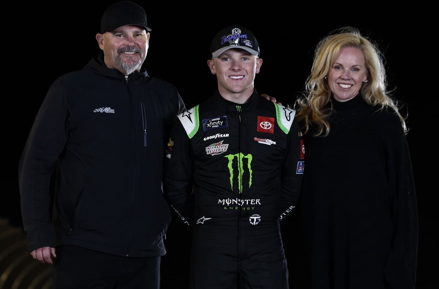 Ty Gibbs poses with his father, Coy Gibbs. and mother, Heather Gibbs, after winning the NASCAR Xfinity Series Championship at Phoenix Raceway on Nov. 5, 2022.