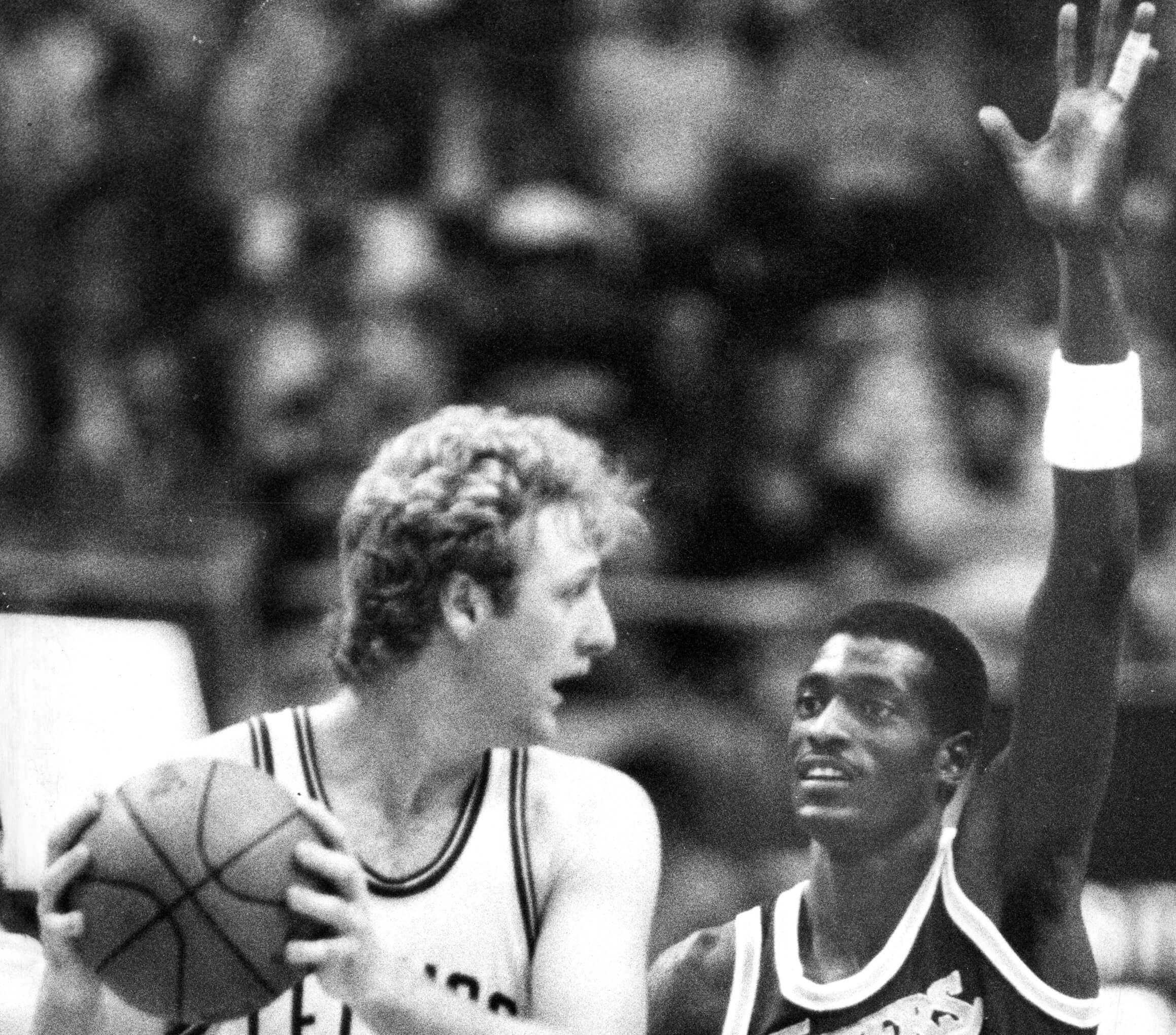 Boston Celtics star Larry Bird, left, is guarded by the Lakers' Michael Cooper.