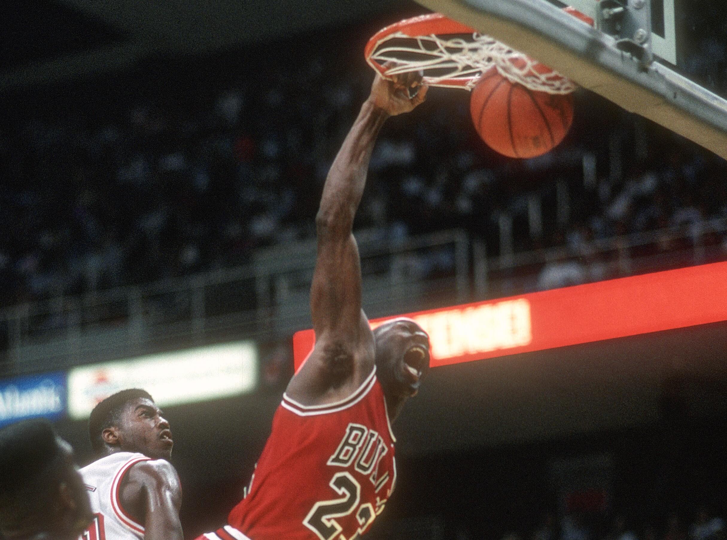 Michael Jordan of the Chicago Bulls slam dunks against the Miami Heat.