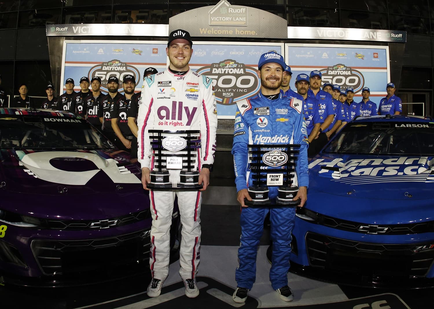 Pole Award winner Alex Bowman and front-row qualifier Kyle Larson pose for photos after the Busch Light Pole at Daytona International Speedway on Feb. 15, 2023.