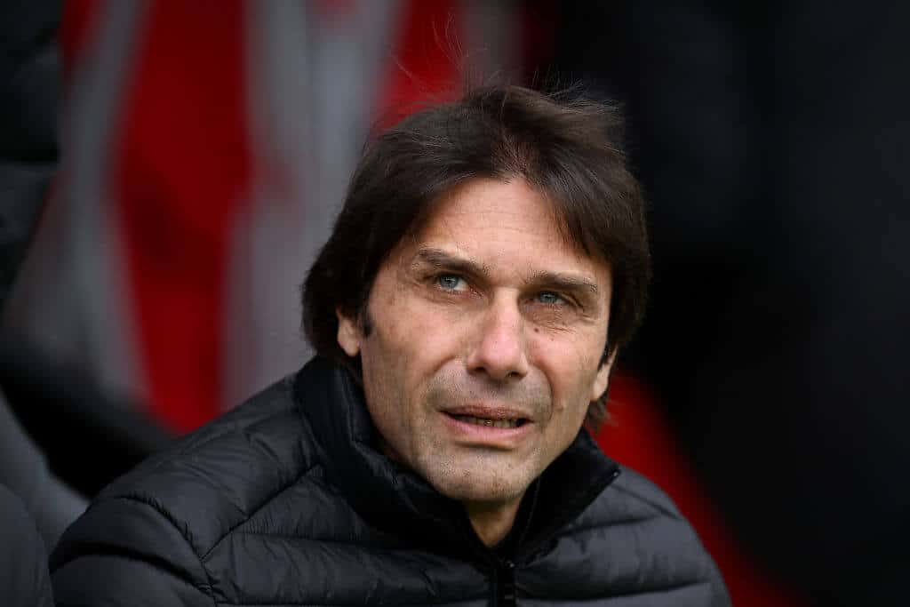 Antonio Conte sits on the bench during a Tottenham Hotspur match.