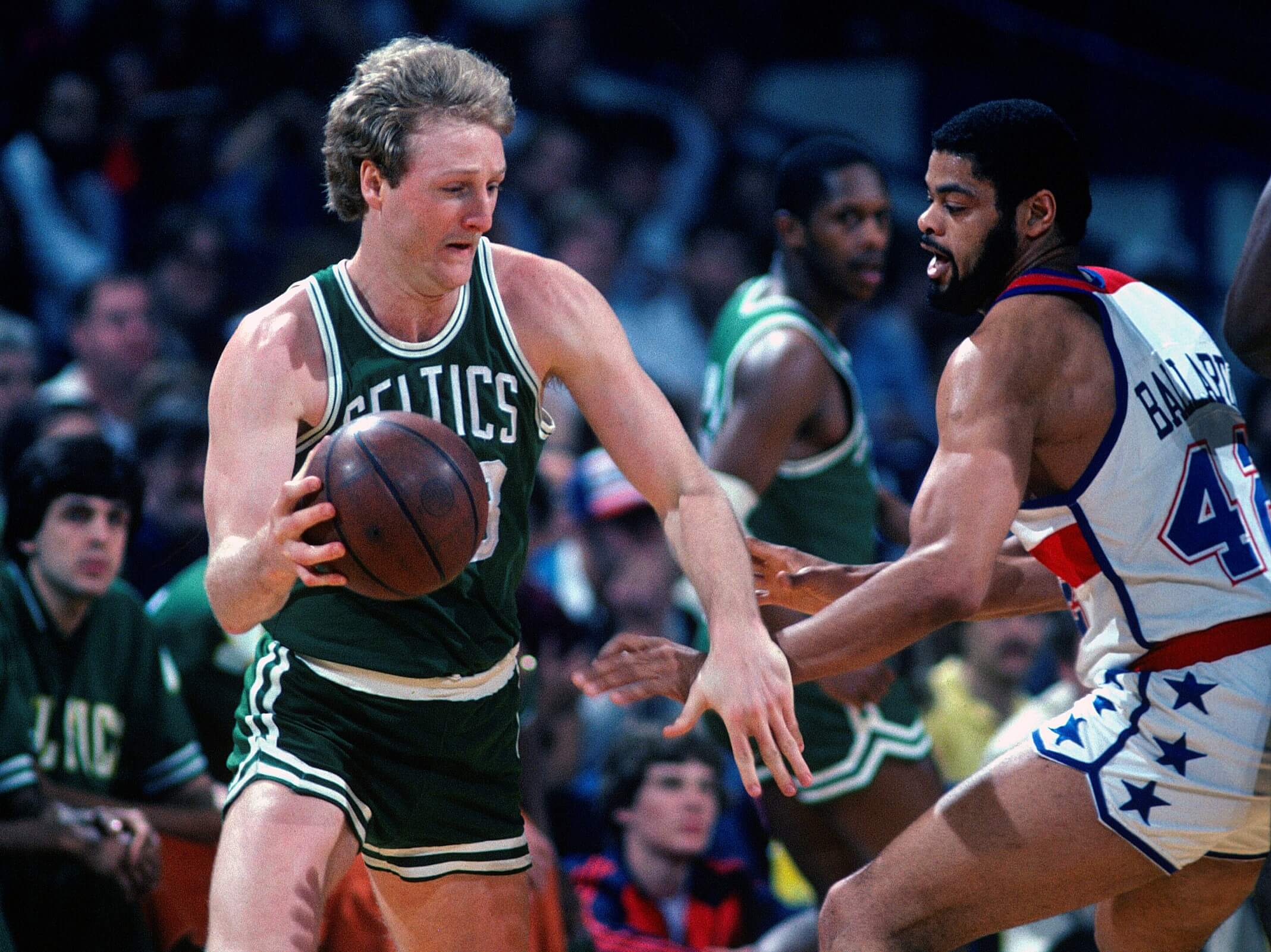 Larry Bird of the Boston Celtics drives on Greg Ballard of the Washington Bullets.