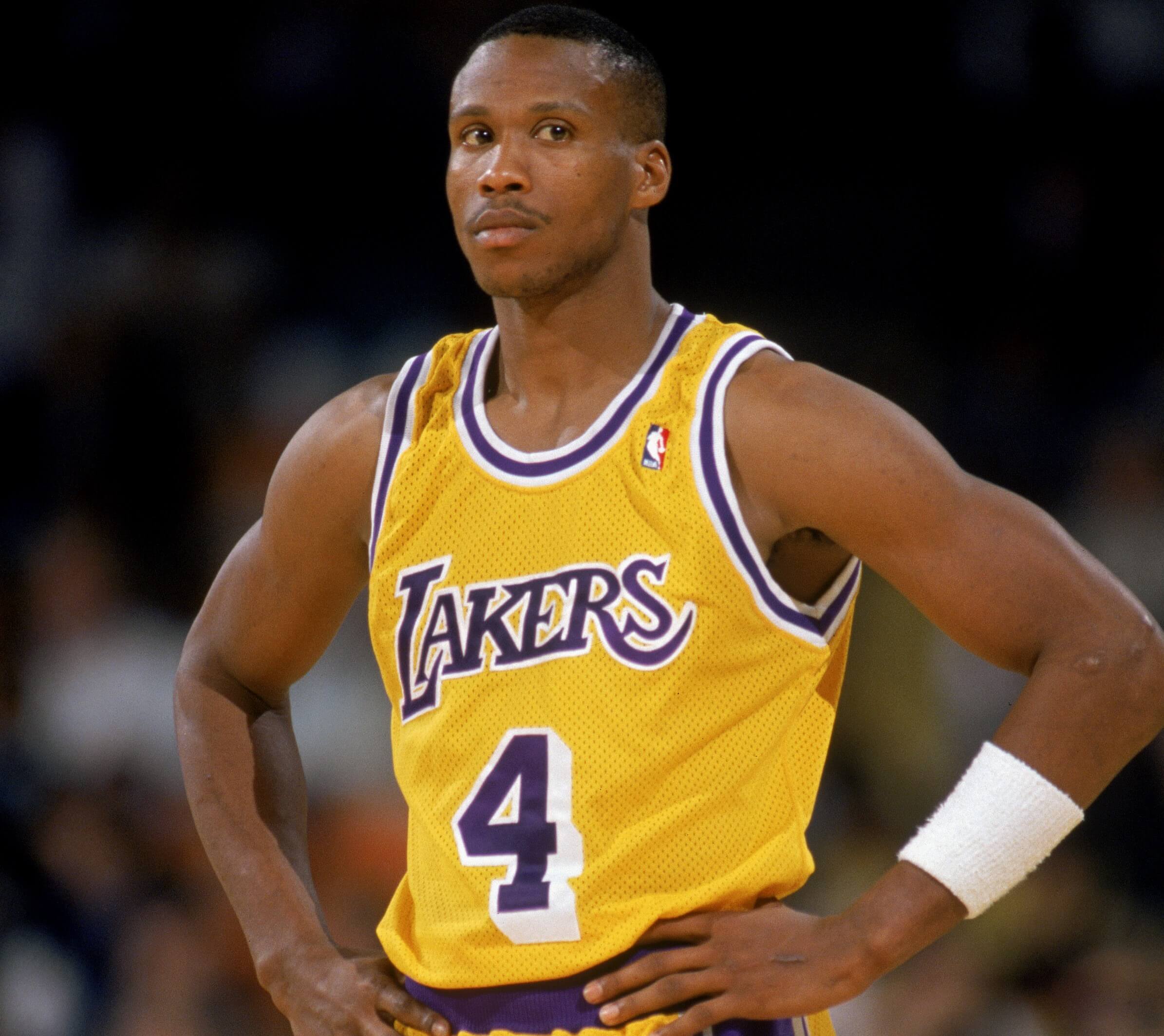 Byron Scott of the Los Angeles Lakers stands on the court.