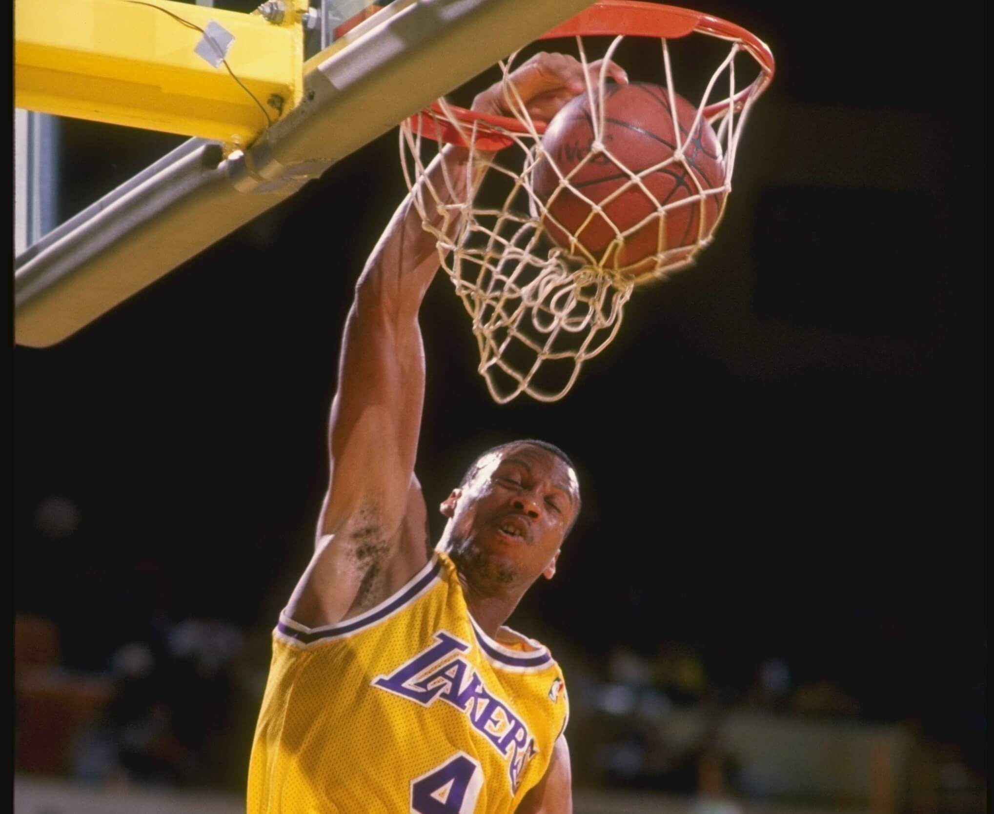 Byron Scott of the Los Angeles Lakers slam dunks during a game.