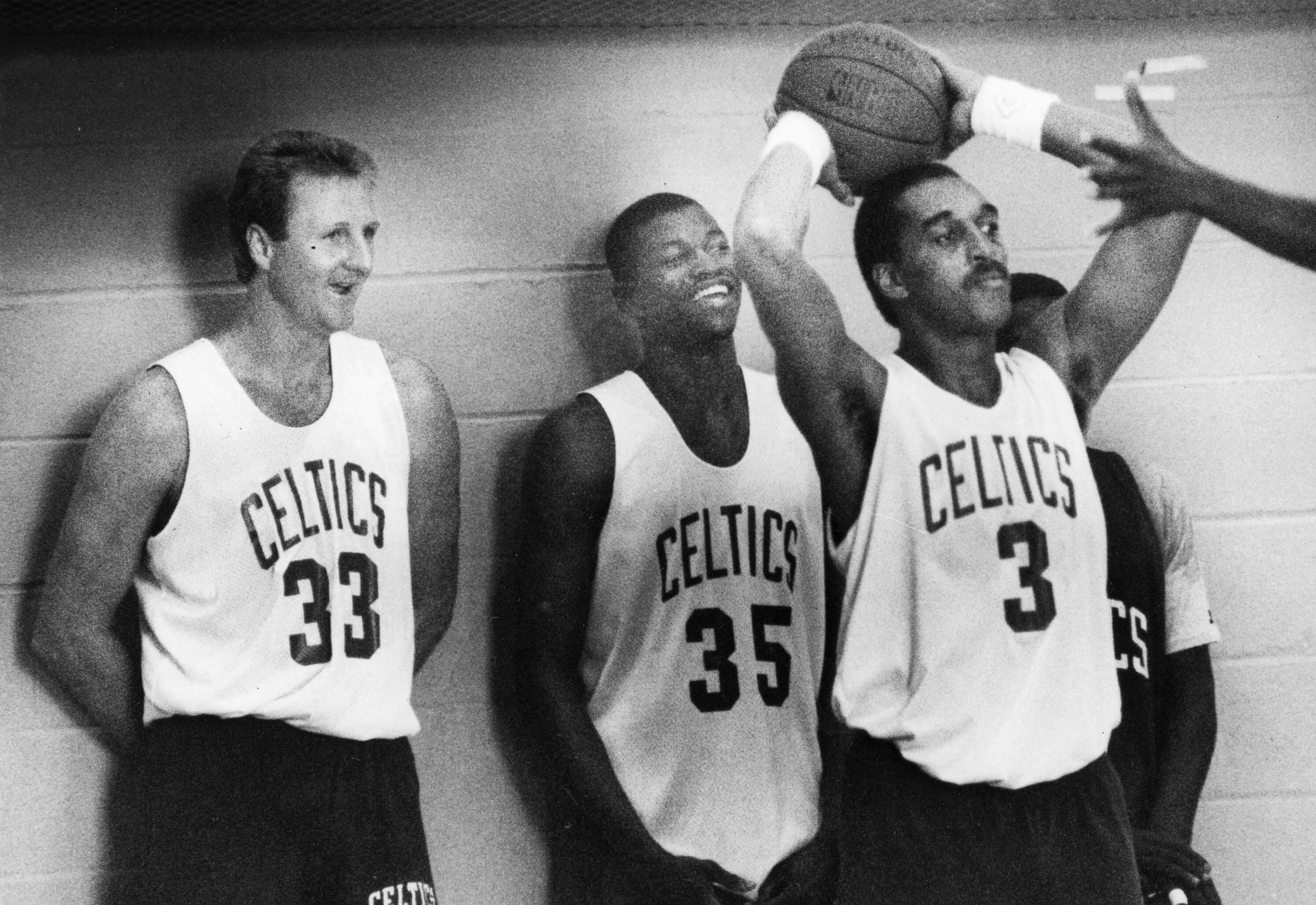 From left, Boston Celtics Larry Bird, Reggie Lewis, and Dennis Johnson participate in drills.