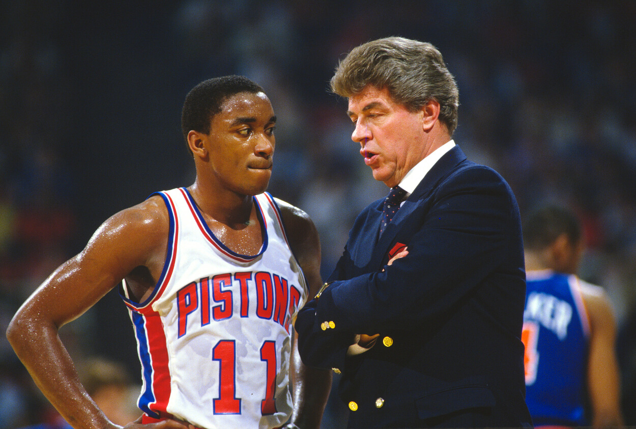 Head coach Chuck Daly of the Detroit Pistons talks with his player Isiah Thomas.