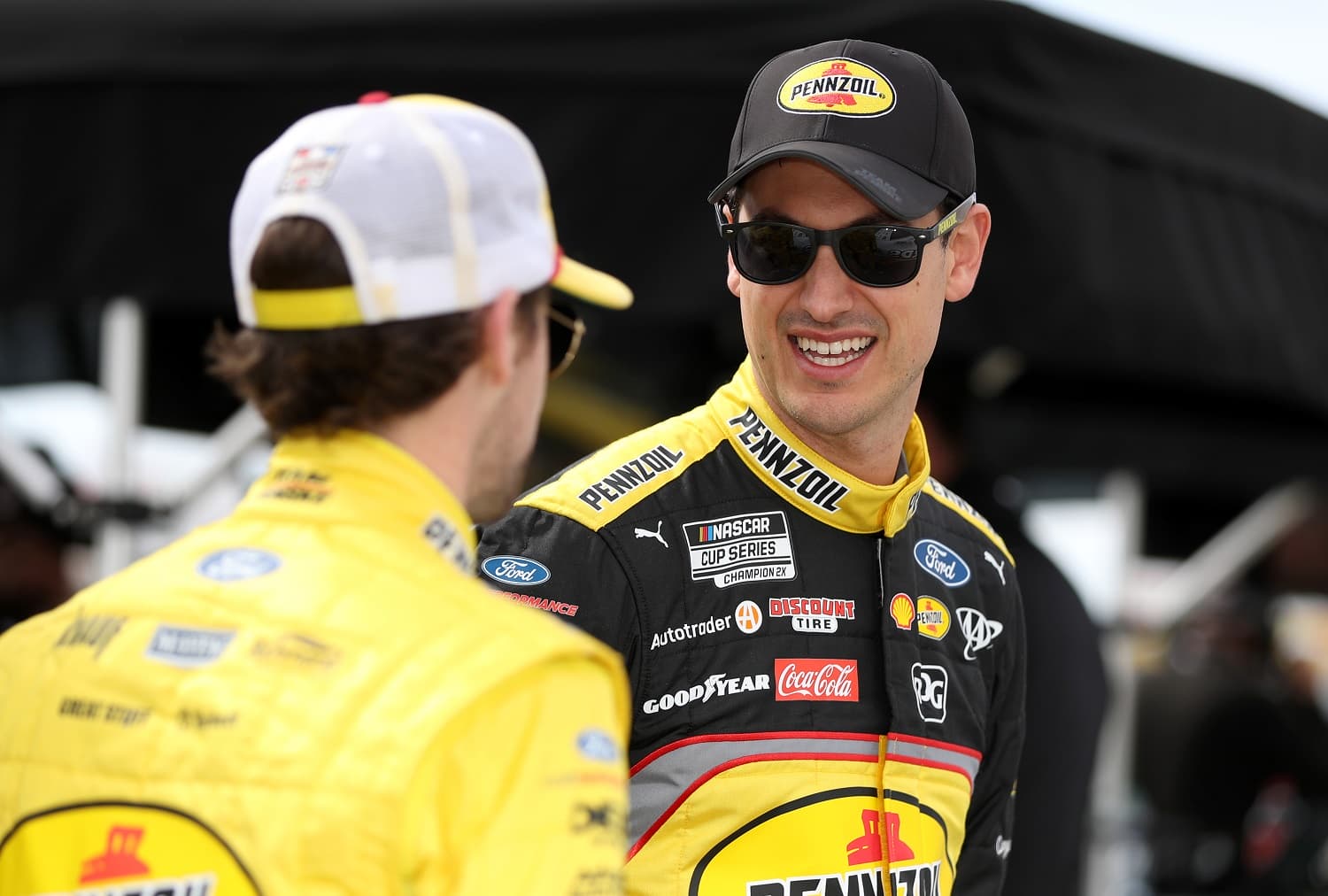 Joey Logano talks to Ryan Blaney on the grid during practice for the NASCAR Cup Series Pennzoil 400 at Las Vegas Motor Speedway on March 4, 2023.