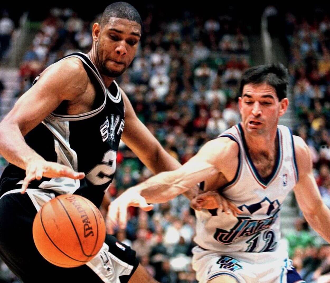 John Stockton steals the ball from Tim Duncan during an NBA game.