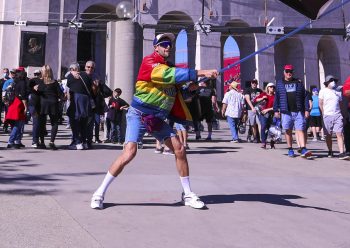 Driver Jordan Taylor, dressed in costume as alter-ego racer Rodney Sandstorm, waves a racing flag as racing fans arrive at the Busch Light Clash At The Coliseum on Feb. 6, 2022.