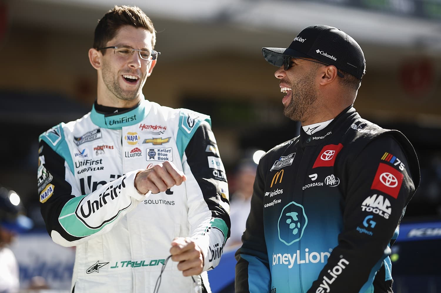 Drivers Jordan Taylor and Bubba Wallace share a laugh during qualifying for the NASCAR Cup Series EchoPark Automotive Grand Prix at Circuit of The Americas on March 25, 2023.