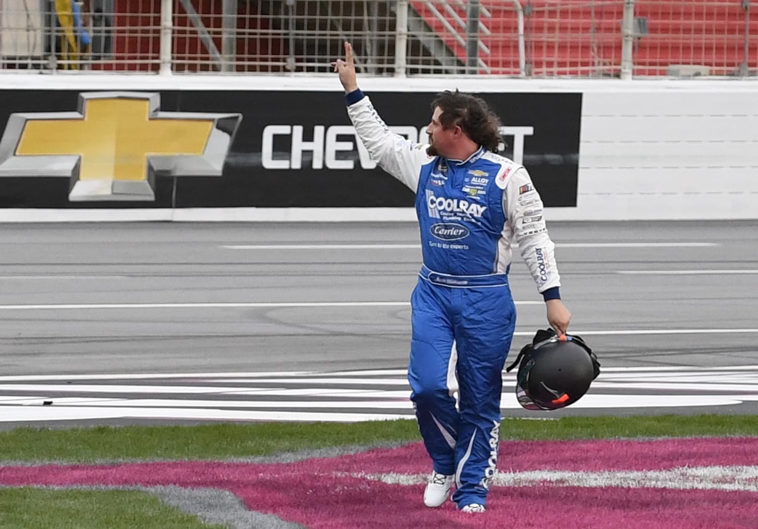 Josh Williams waves to the crowd after leaving his car on the track during the NASCAR Xfinity Series Raptor King of Tough 250 on March 18, 2023, at Atlanta Motor Speedway.