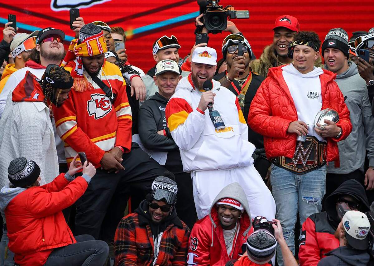 Kansas City Chiefs tight end Travis Kelce addresses the crowd as quarterback Patrick Mahomes and teammates look on after winning Super Bowl LVII