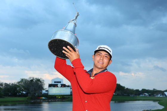 Kurt Kitayama celebrates with the Arnold Palmer Invitational trophy.