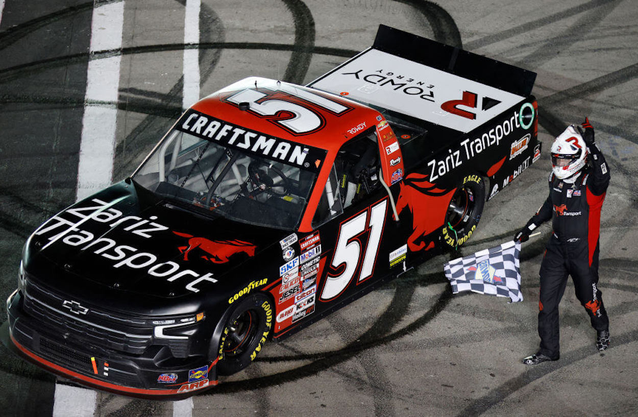 Kyle Busch celebrates victory at the NASCAR CRAFTSMAN Truck Series Victoria's Voice Foundation 200.