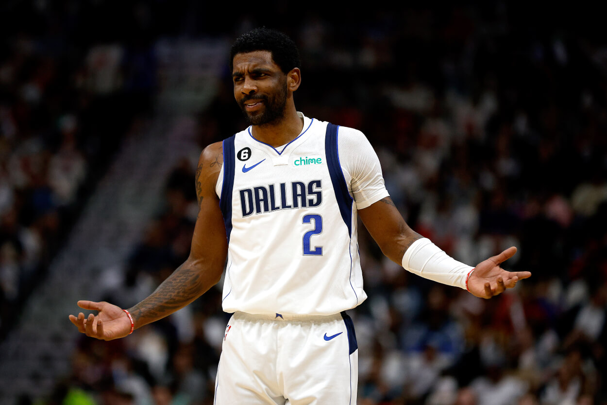 Kyrie Irving of the Dallas Mavericks reacts to a fan.