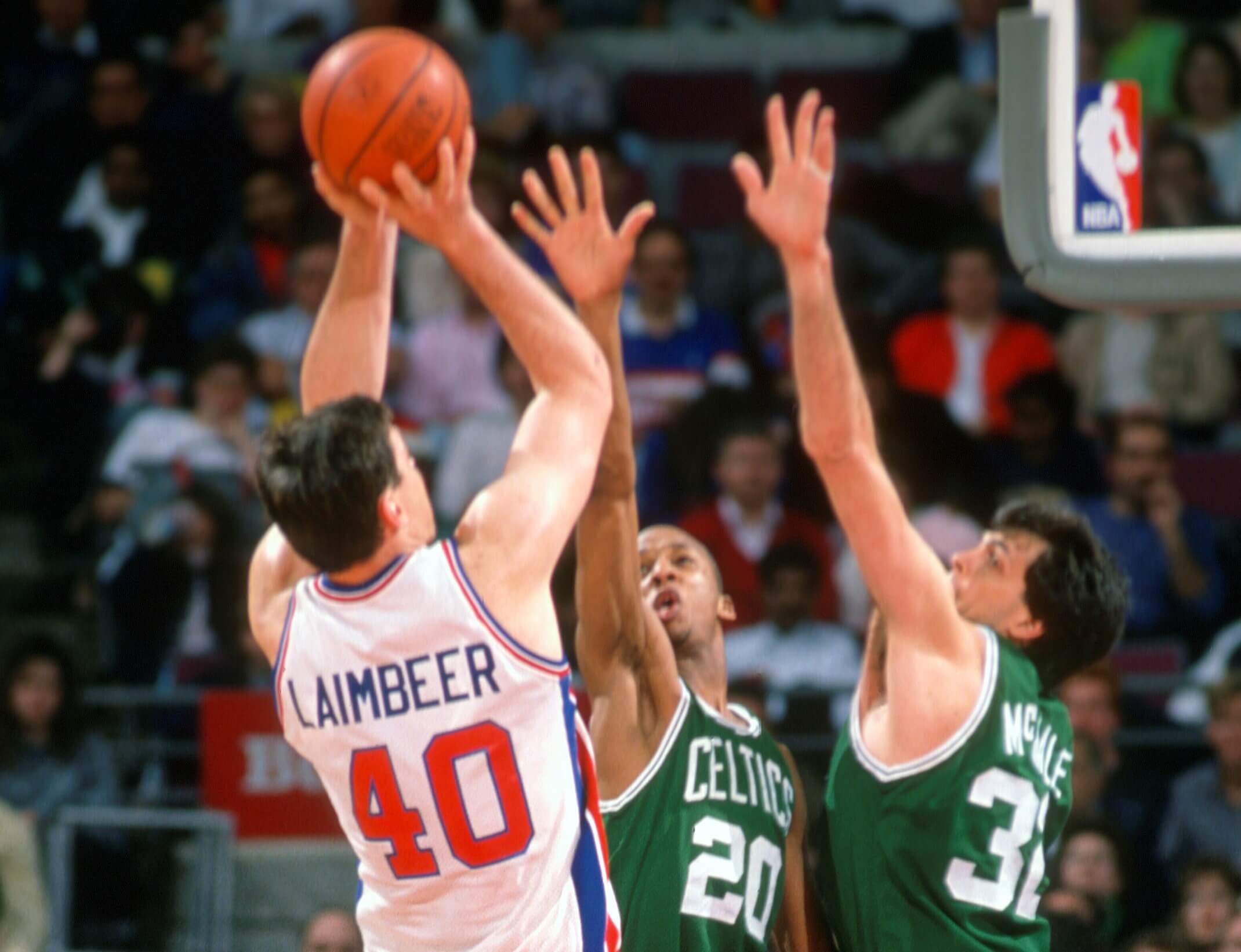 Bill Laimbeer of the Detroit Pistons shoots over Kevin McHale and Brian Shaw of the Boston Celtics.