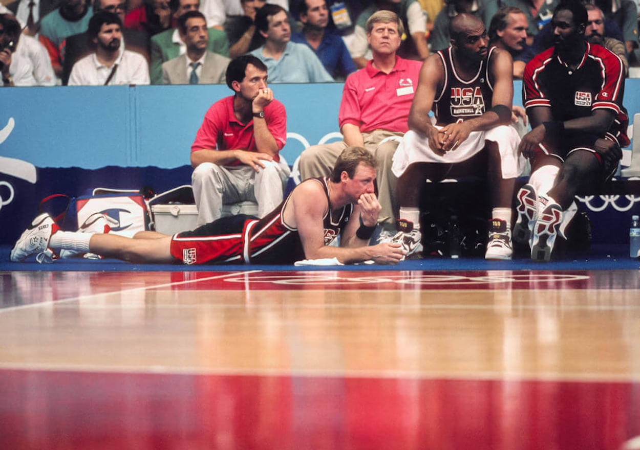 Larry Bird rests on the floor during a Dream Team game.