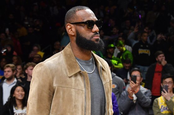 LeBron James watches a game from the sidelines.