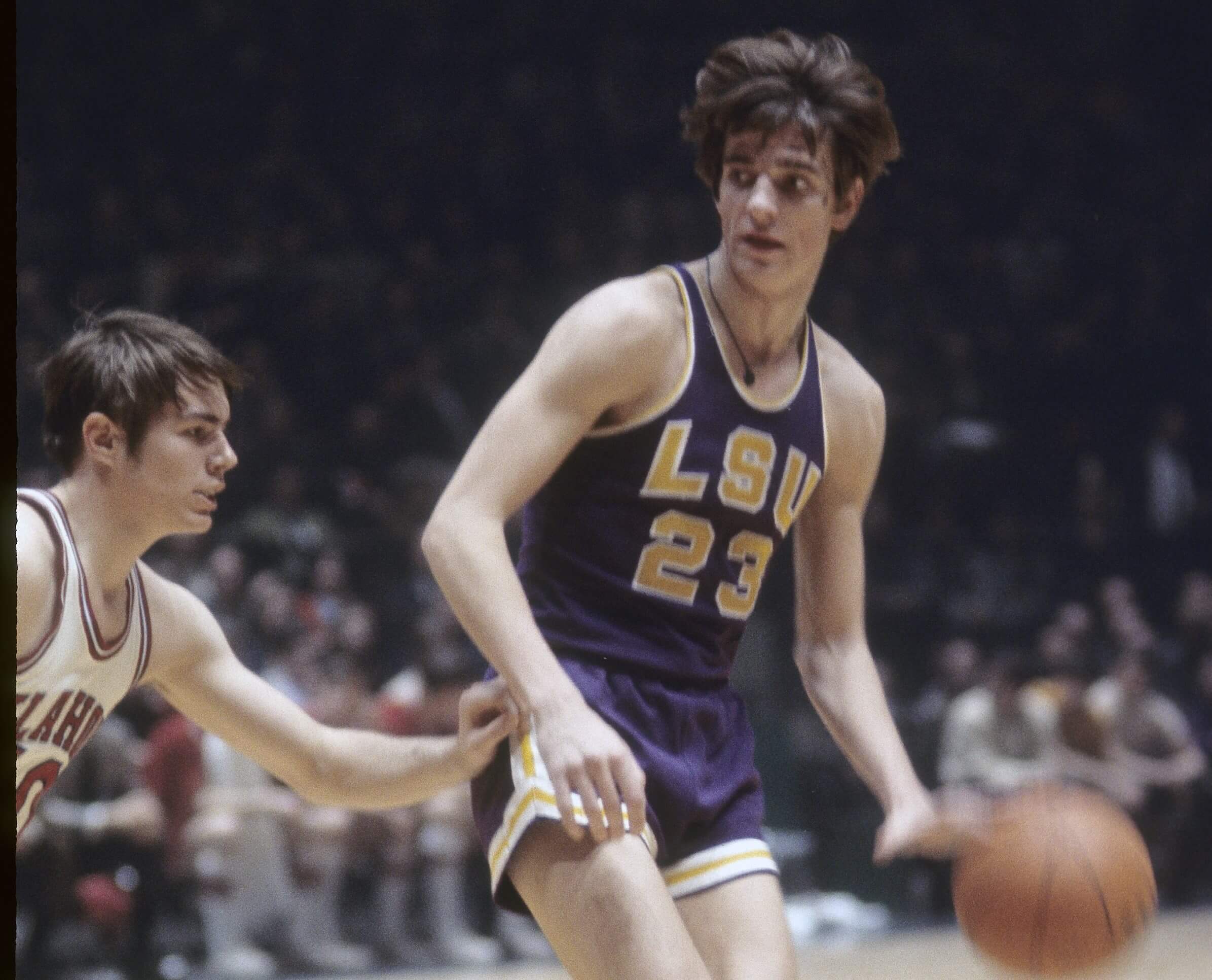 Pete Maravich of the Louisiana State University Tigers is guarded closely by an Oklahoma Sooners defender.