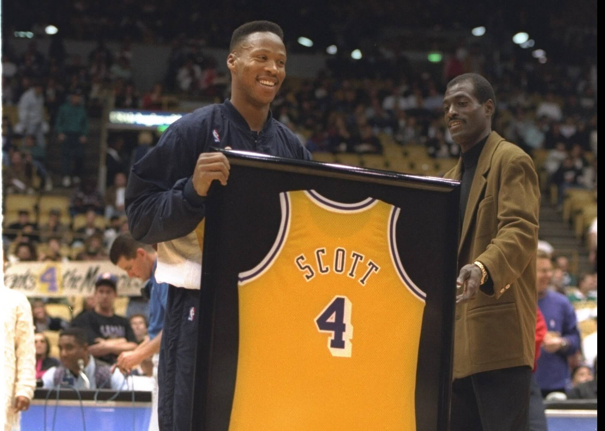 Guard Byron Scott of the Indiana Pacers, and former Los Angeles Laker, is presented with a framed Lakers jersey by former teammate Michael Cooper.