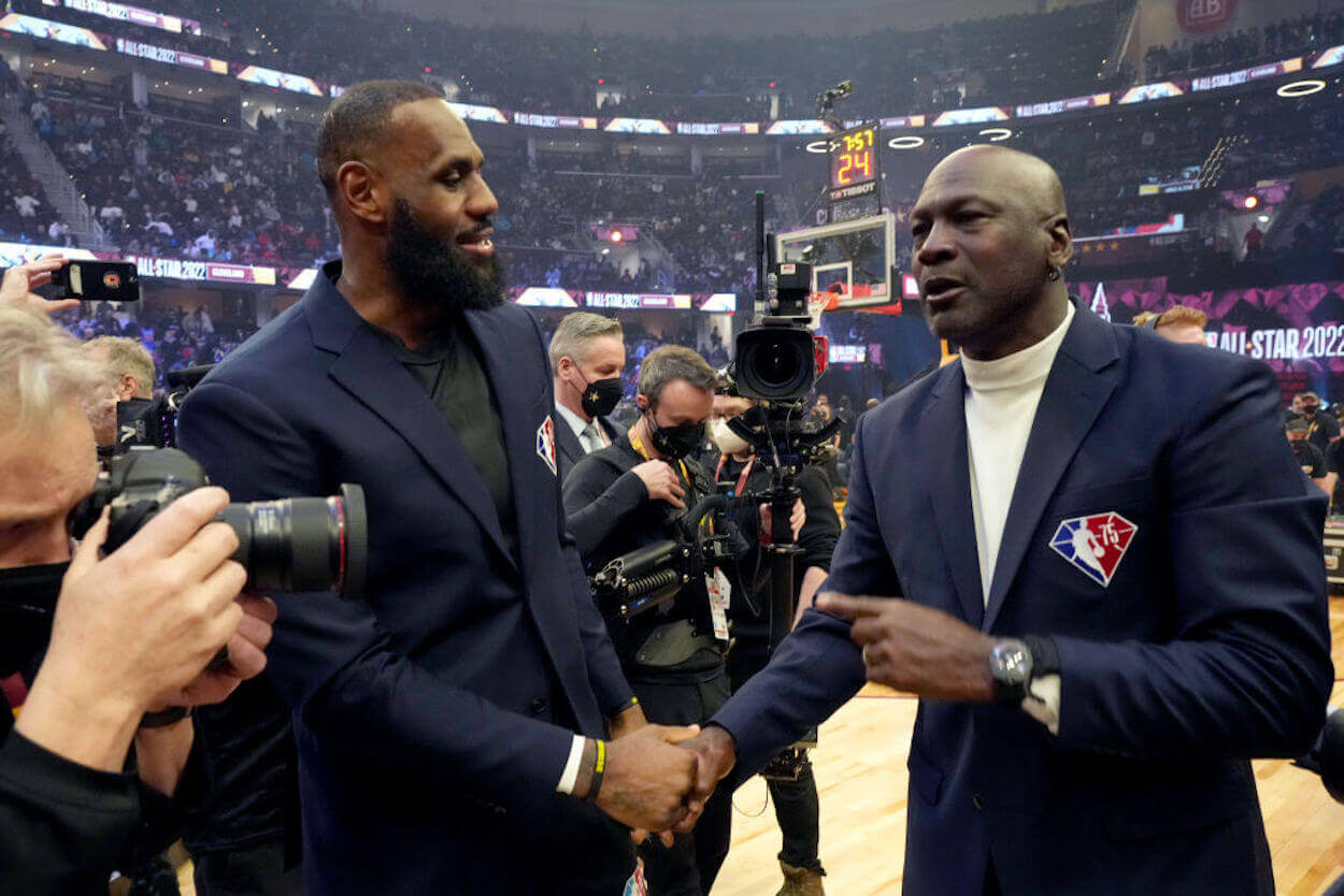 LeBron James (L) and Michael Jordan (R) shake hands at the 2022 NBA All-Star Game