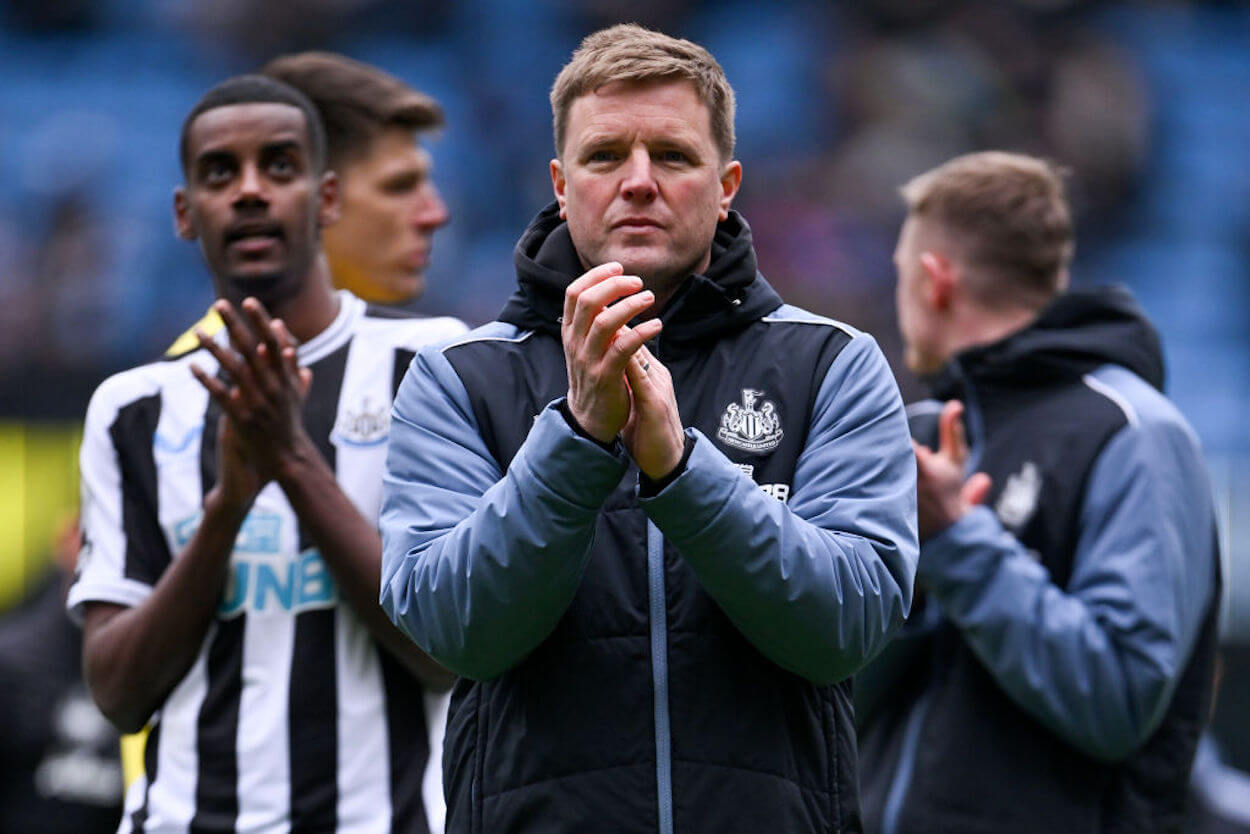 Eddie Howe (C) and his Newcastle team applaud their supporters.