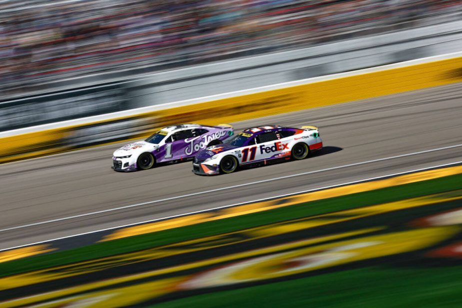Denny Hamlin (L) and Ross Chastain (R) race side-by-side at Las Vegas Motor Speedway.