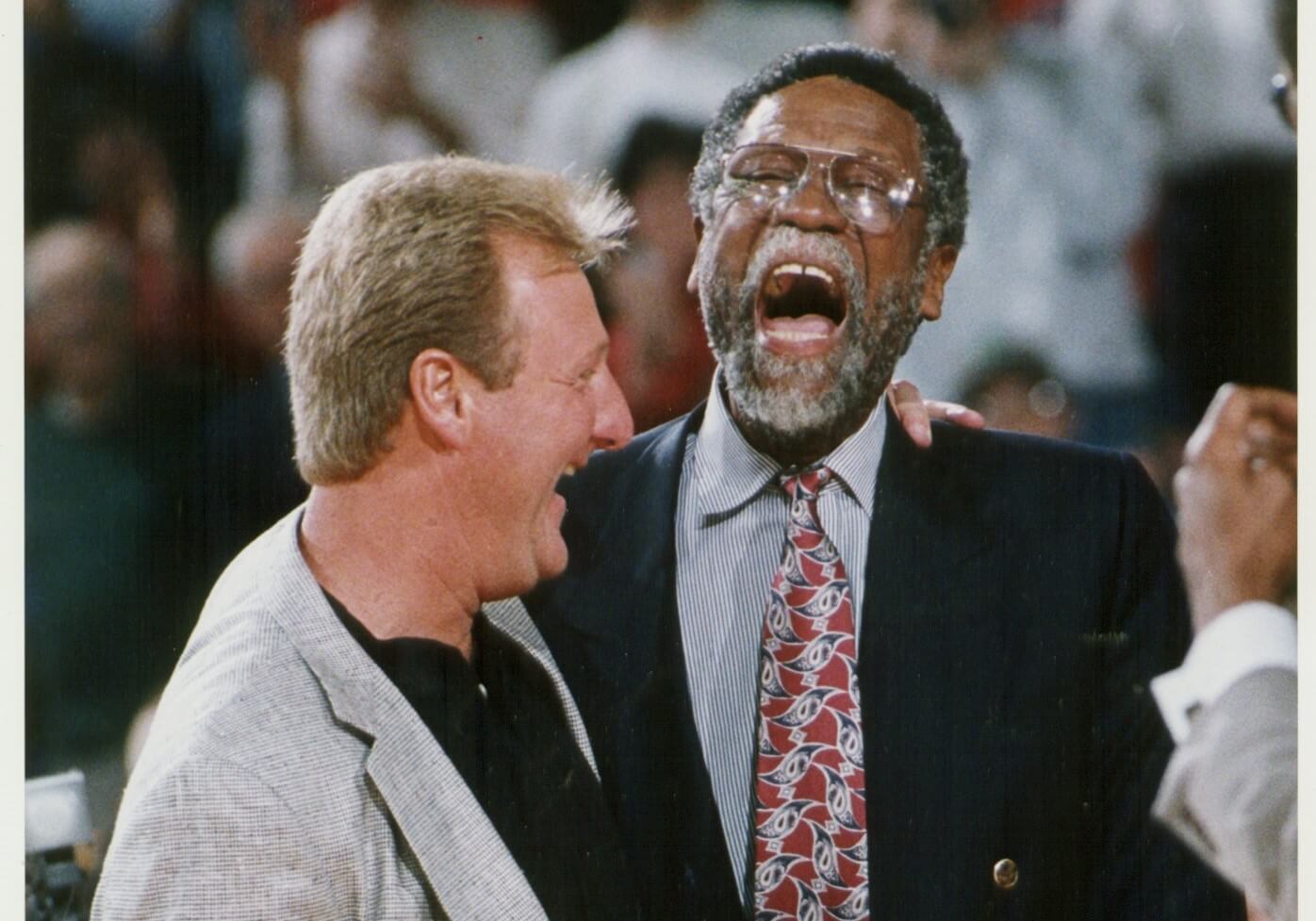 Boston Celtics legends Larry Bird and Bill Russell share a laugh.