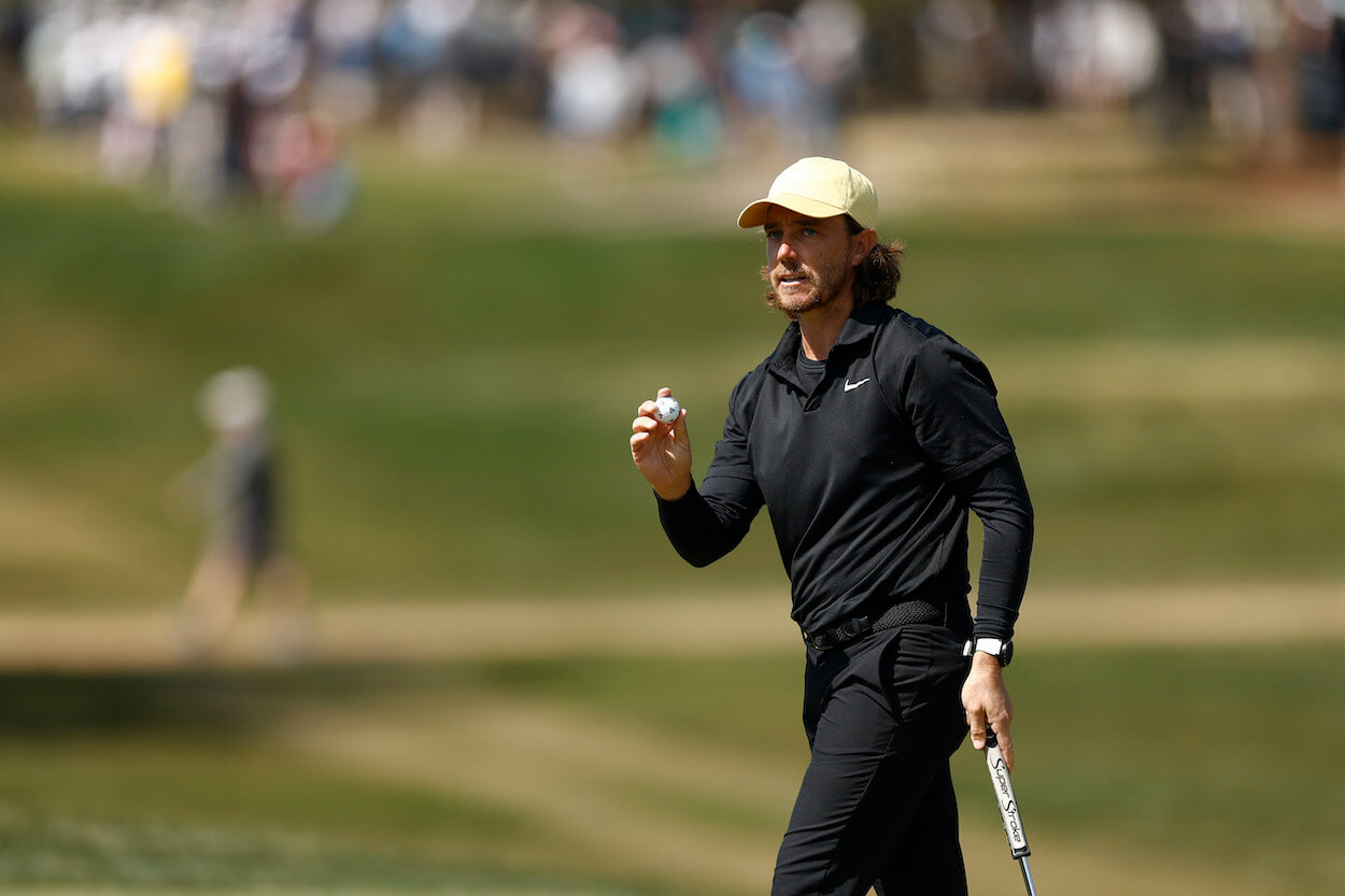 Tommy Fleetwood waves to the gallery.