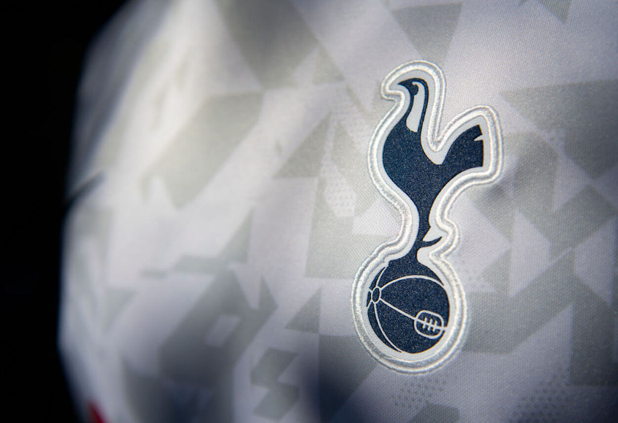 The Tottenham Hotspurs badge on a white jersey.