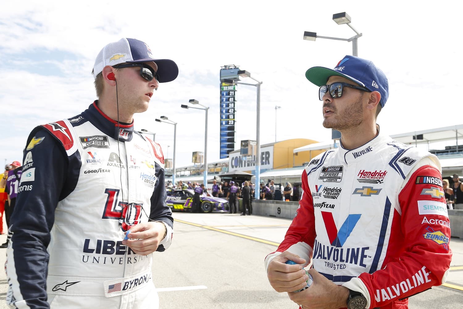 William Byron and Kyle Larson of Hendrick Motorsports talk on the grid during qualifying for the NASCAR Cup Series Dixie Vodka 400 at Homestead-Miami Speedway on Oct. 22, 2022. | Jared East/Getty Images