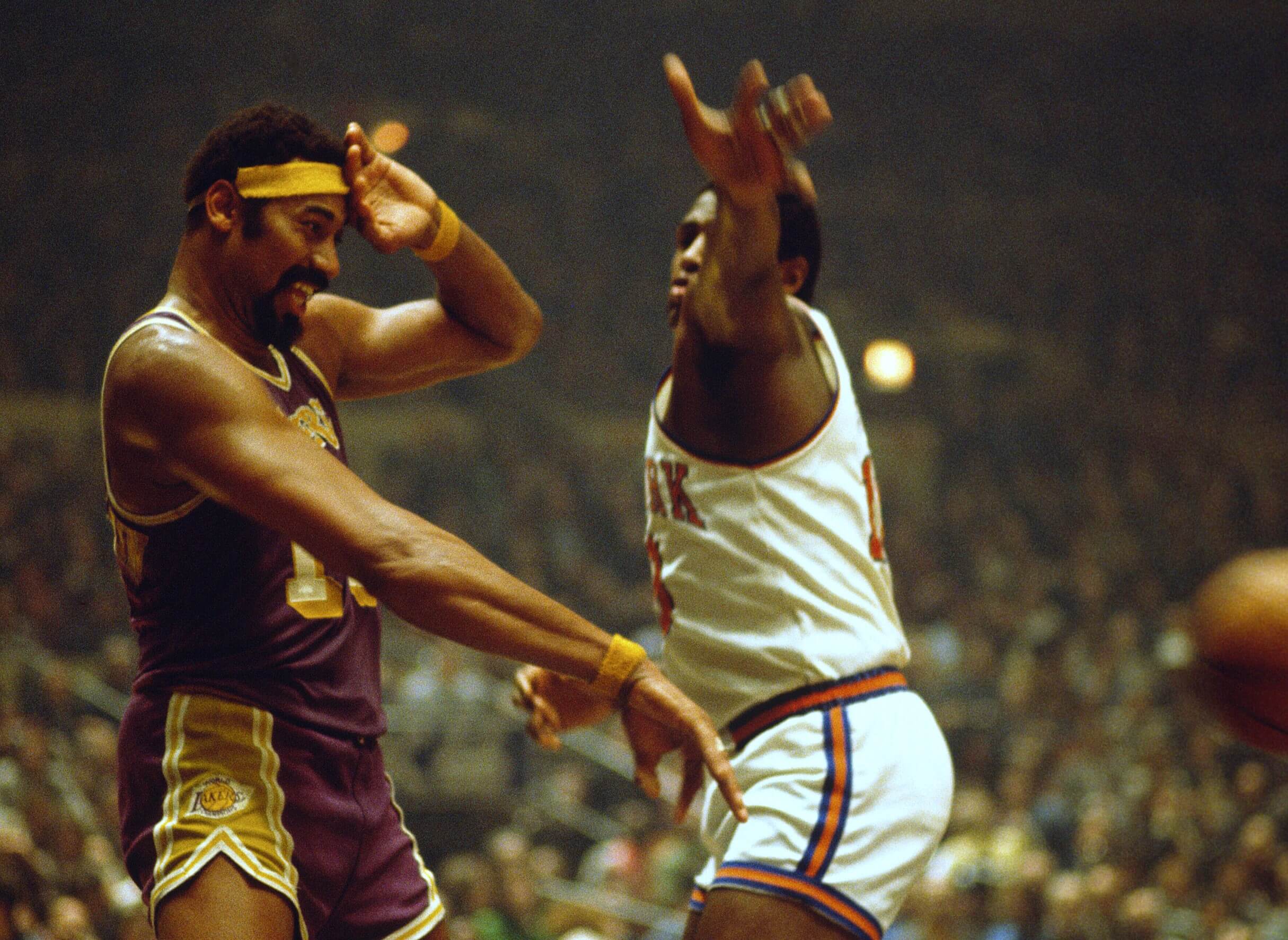 Wilt Chamberlain of the Los Angeles Lakers battles for position with Willis Reed of the New York Knicks.