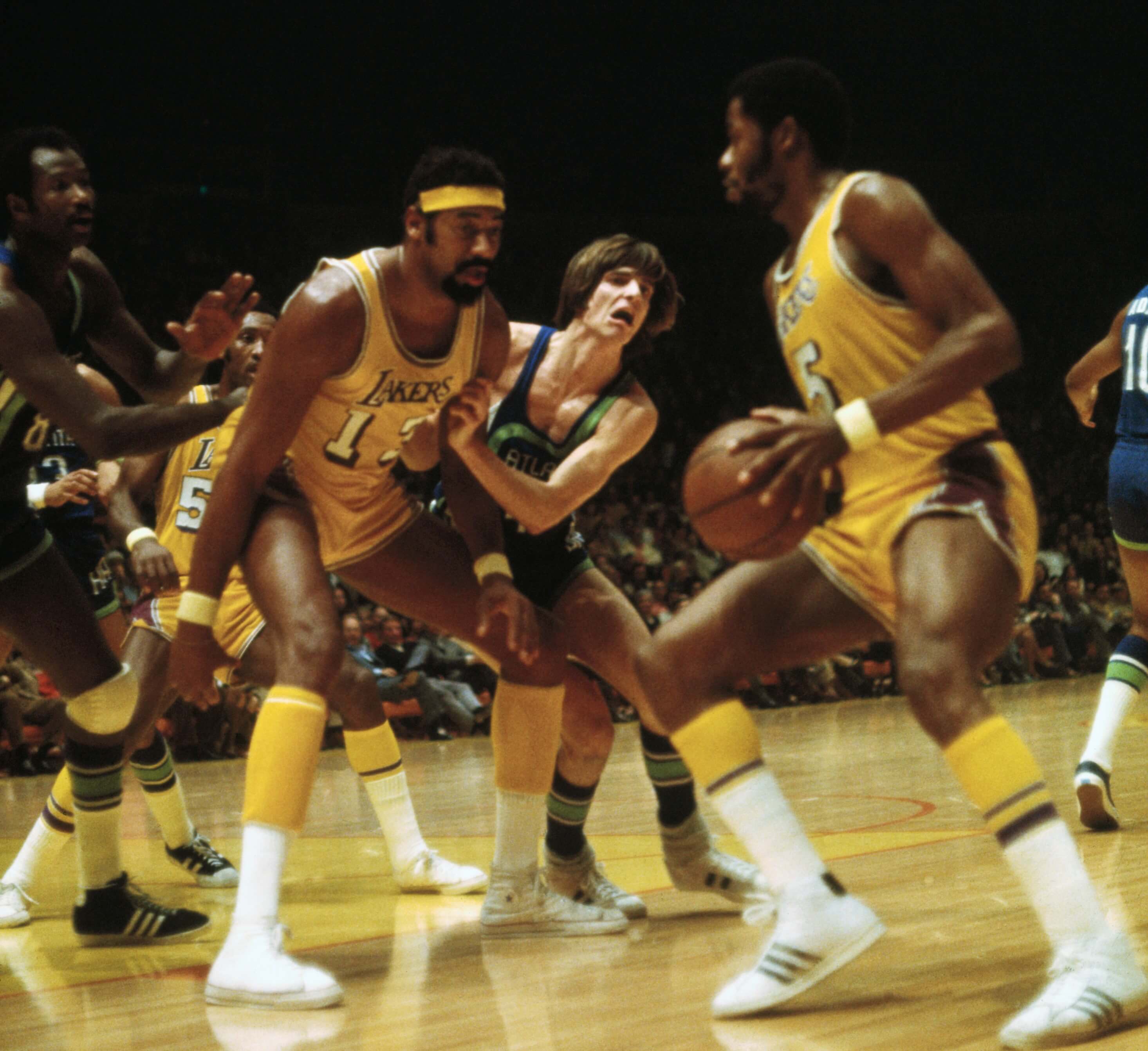 Wilt Chamberlain of the Los Angeles Lakers blocks Pete Maravich of the Atlanta Hawks.