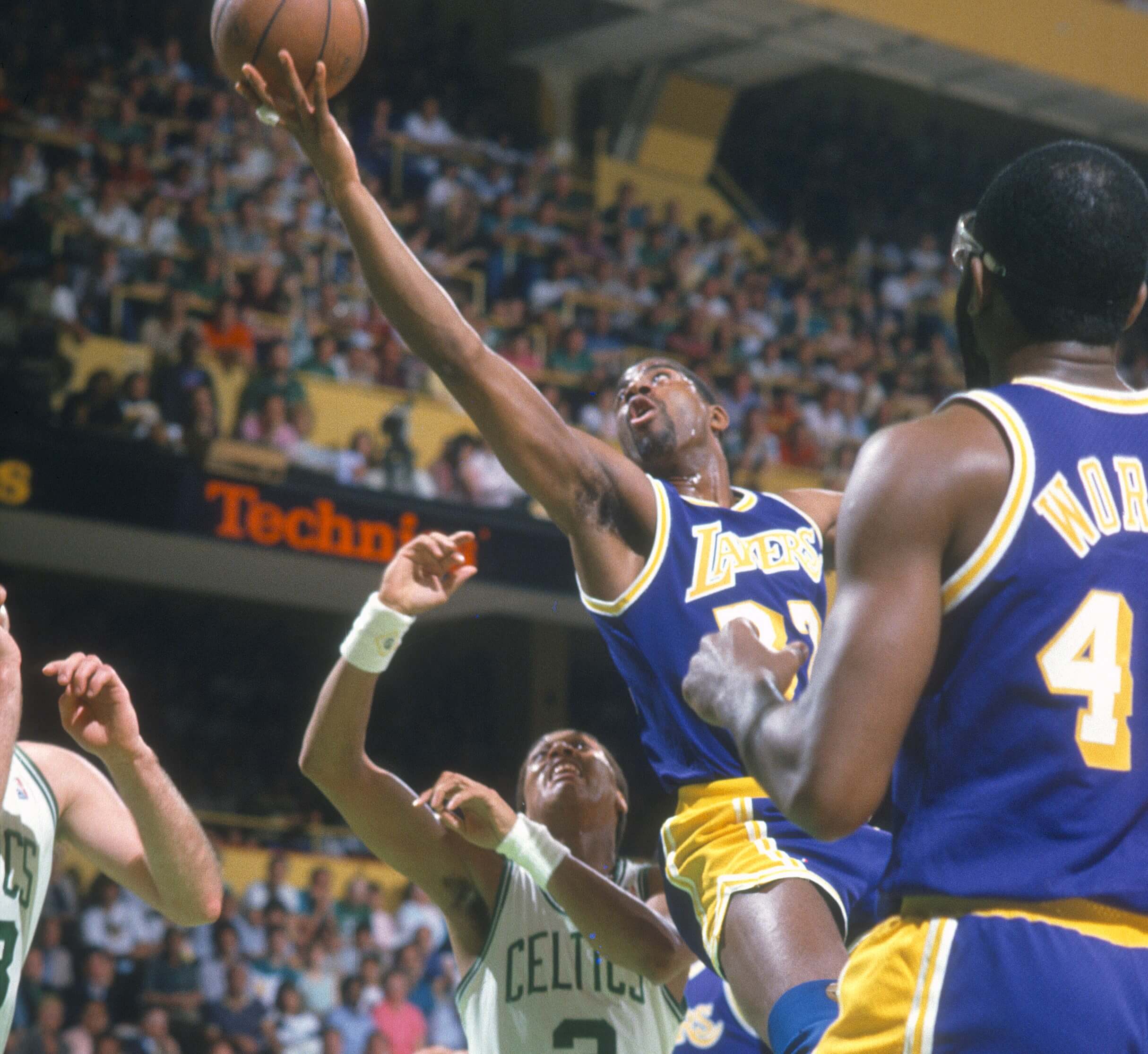 Magic Johnson of the Los Angeles Lakers shoots over Dennis Johnson of the Boston Celtics.