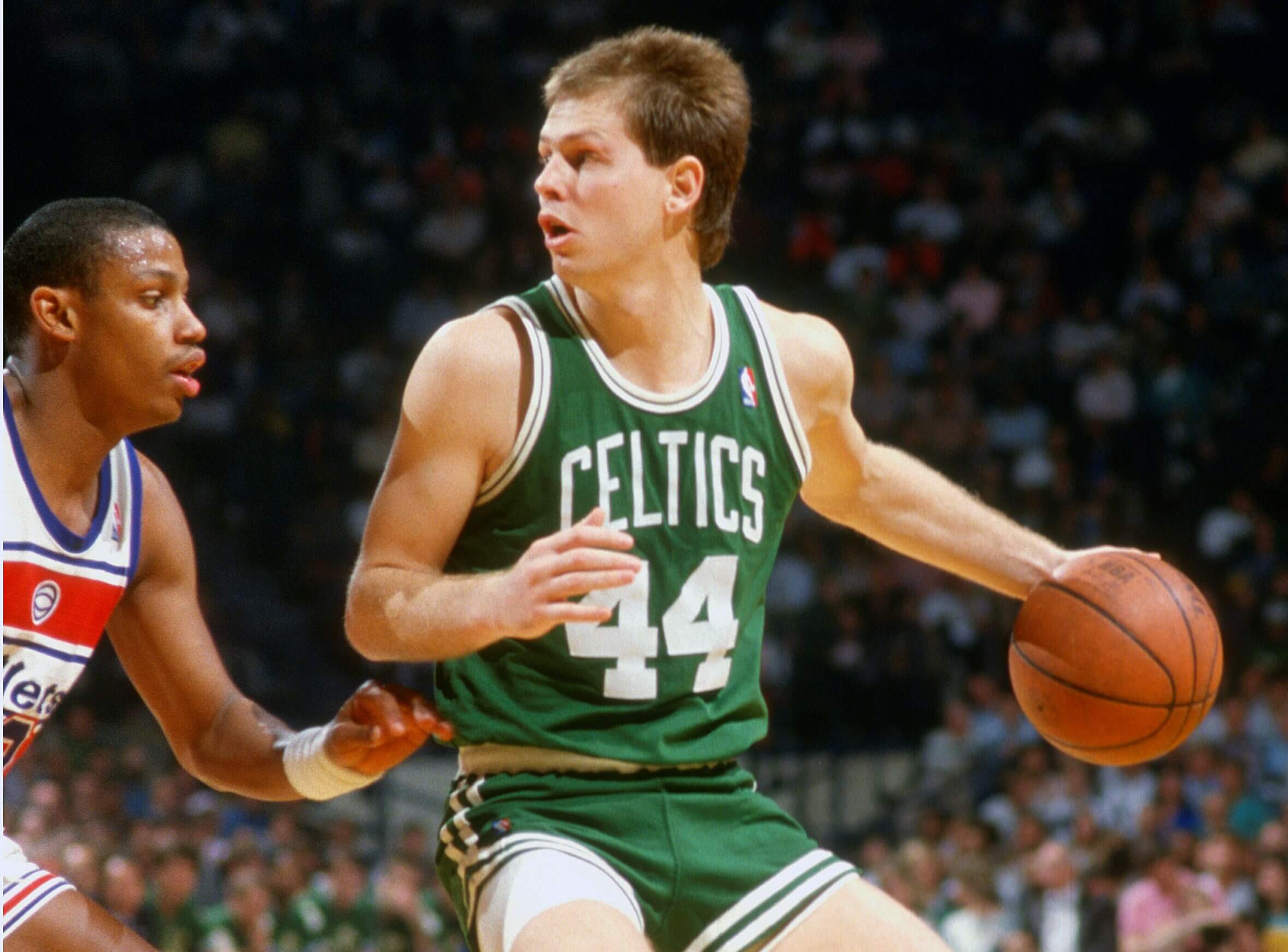 Danny Ainge of the Boston Celtics dribbles the ball against the Washington Bullets.