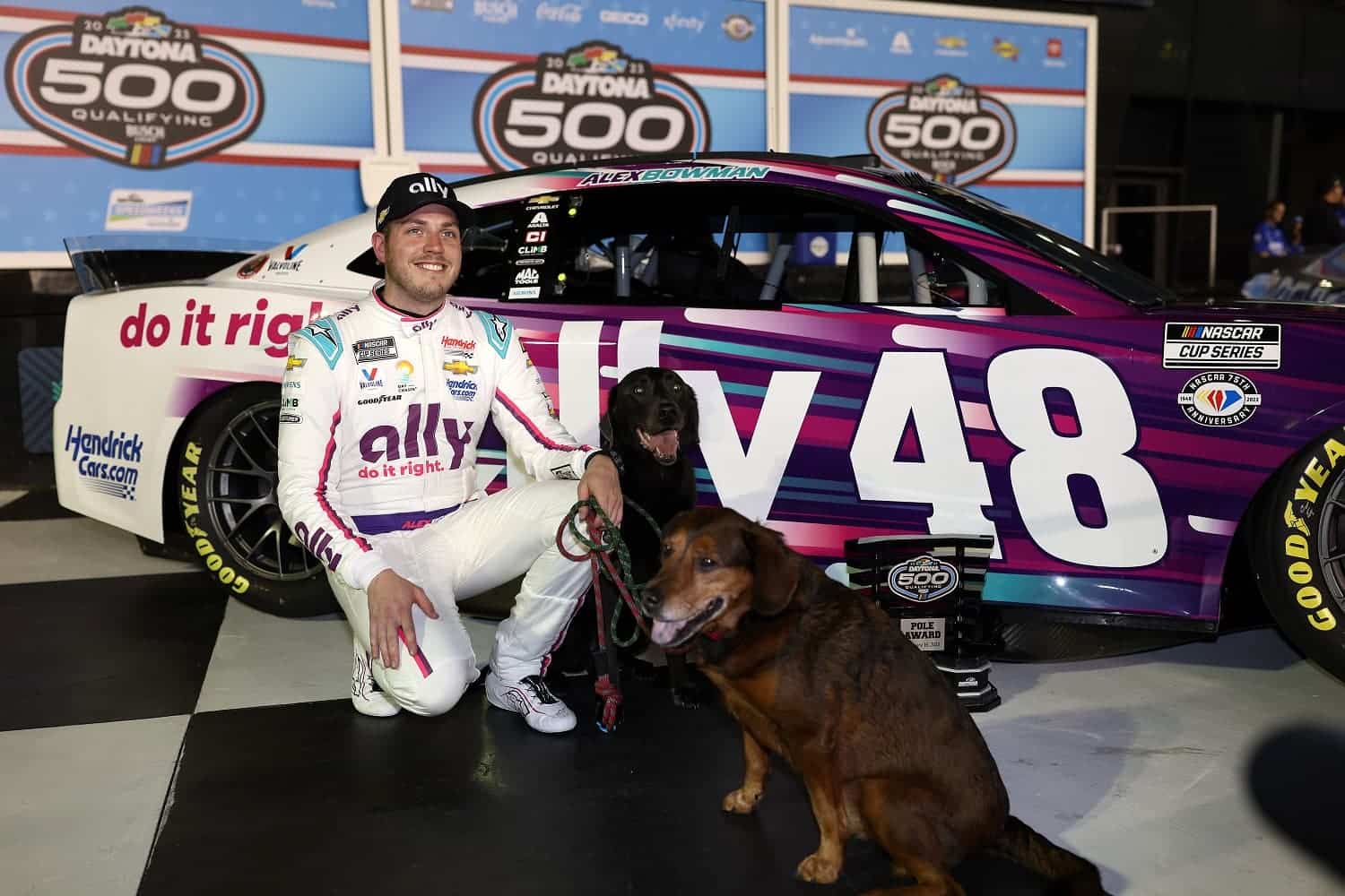 Alex Bowman poses for photos after winning the the Busch Light Pole Award at Daytona International Speedway on Feb. 15, 2023.