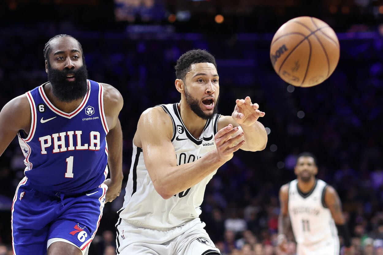 Ben Simmons passes in front of James Harden.