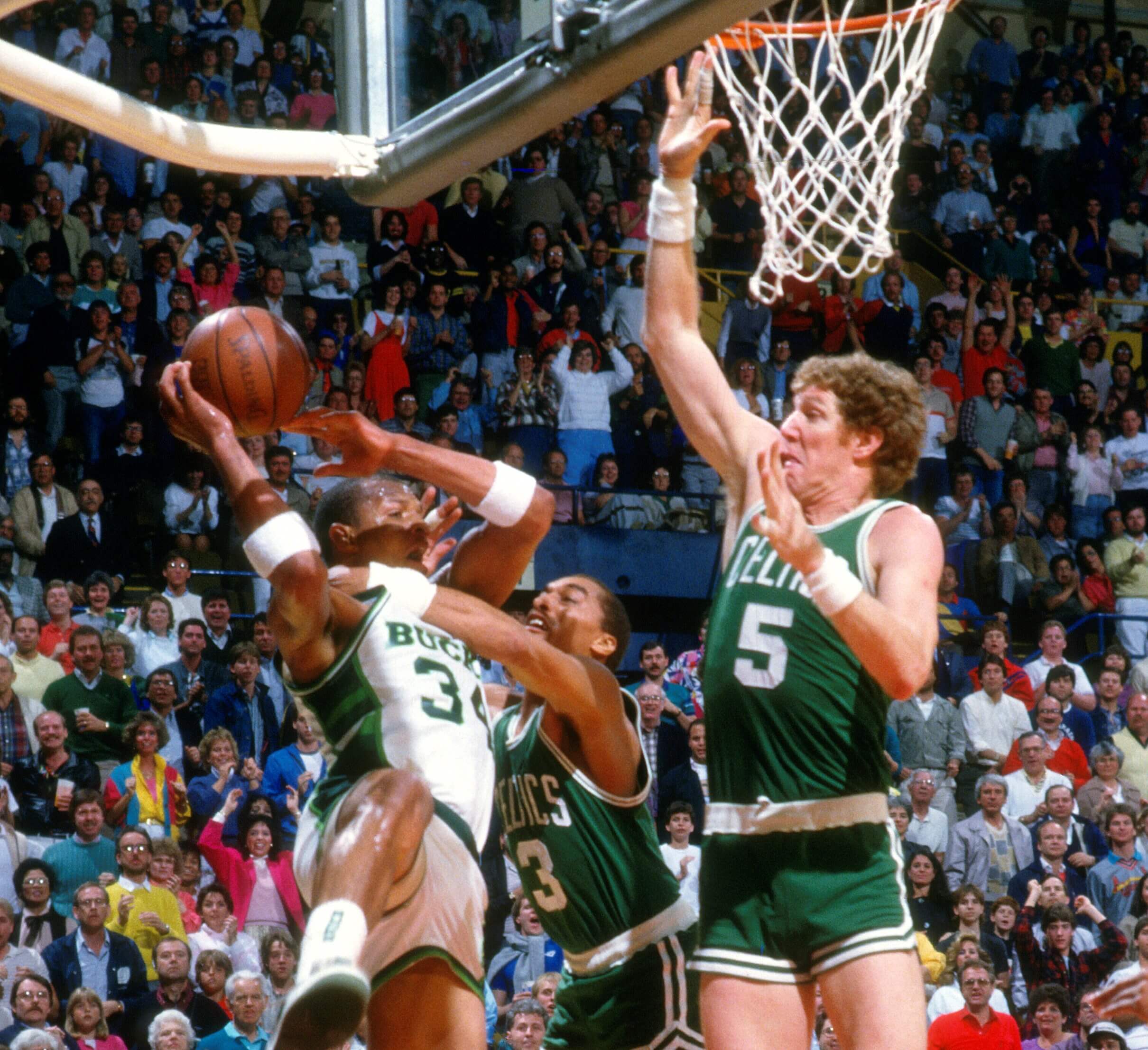 Bill Walton of the Boston Celtics goes up to block the shot of Terry Cummings of the Milwaukee Bucks.