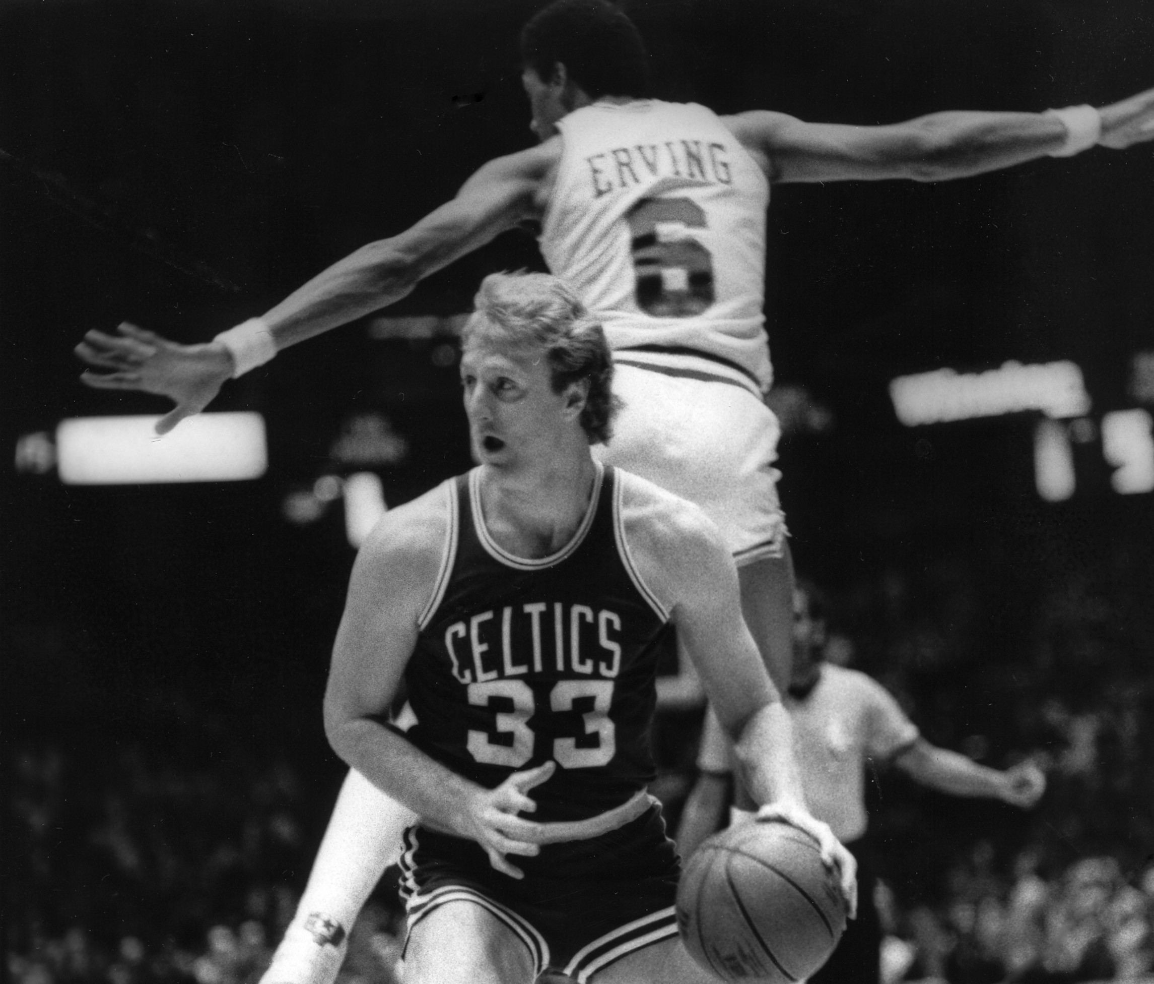 Larry Bird of the Boston Celtics circa 1982 dribbles by Julius Erving of the Philadelphia 76ers.