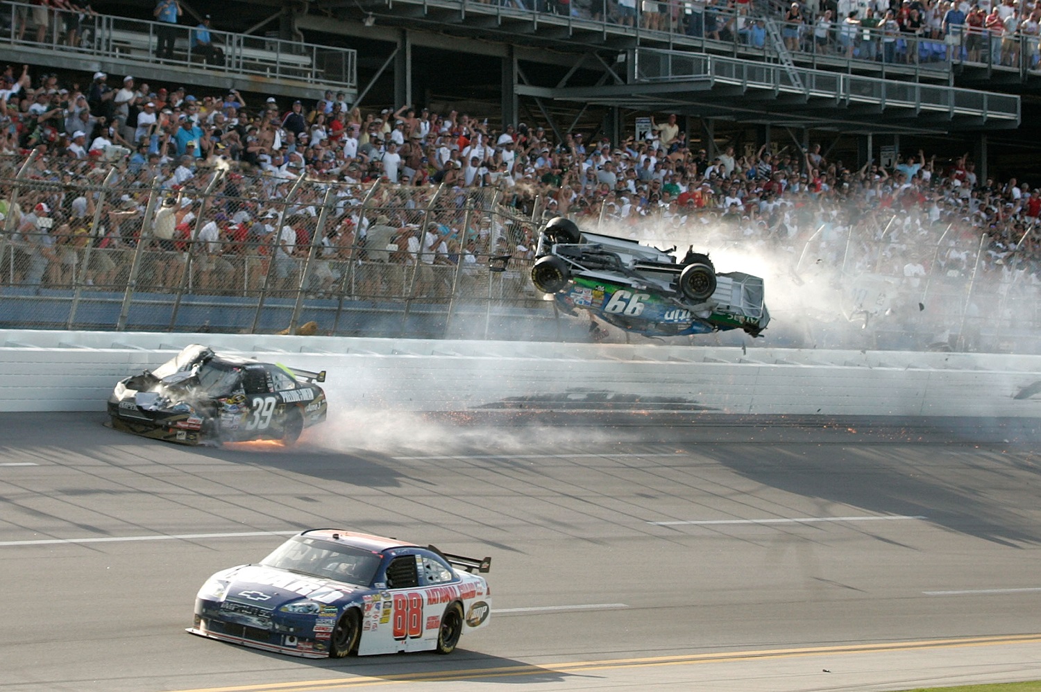Carl Edwards goes airborne as the car of Ryan Newman suffers damage and Dale Earnhardt Jr. drives by on the inside in the Aaron's 499 at Talladega Superspeedway on April 26, 2009.