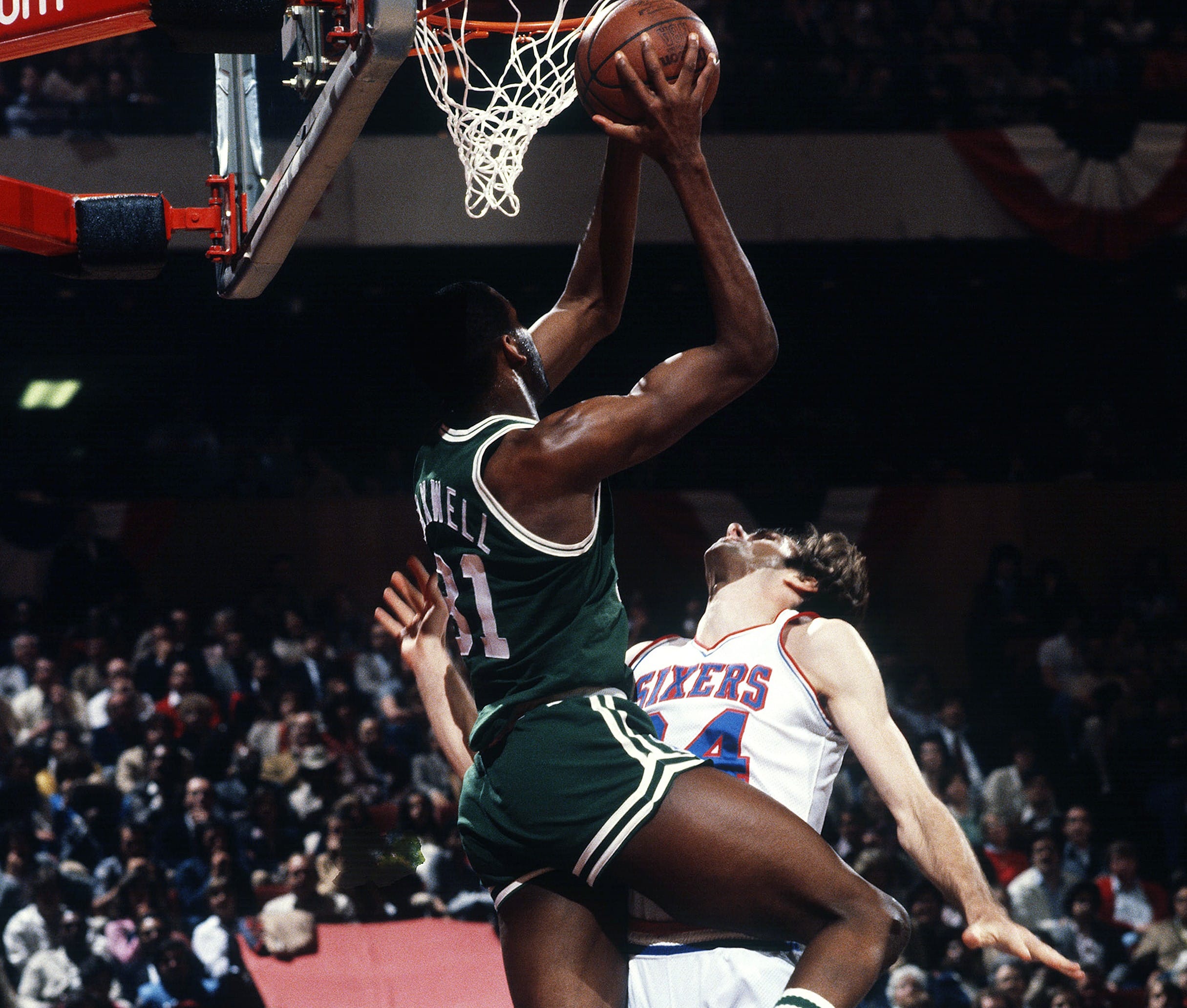 Cedric Maxwell goes up to shoot over Bobby Jones of the Philadelphia 76ers.