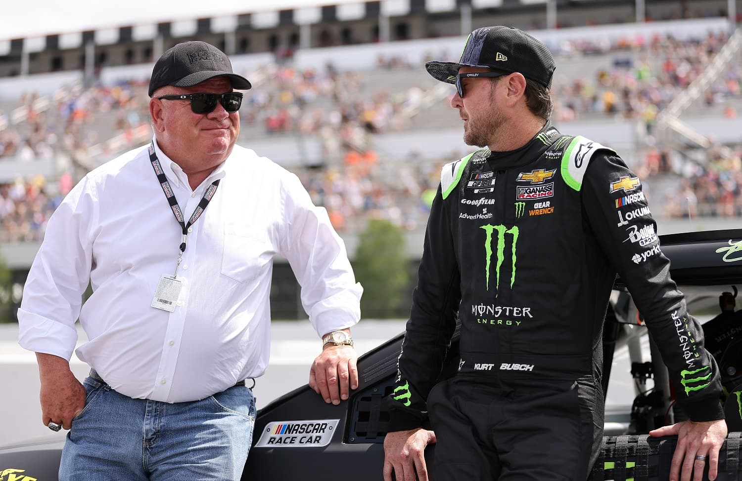 Driver Kurt Busch and team owner Chip Ganassi talk on the grid prior to the NASCAR Cup Series Pocono Organics CBD 325 at Pocono Raceway on June 26, 2021.