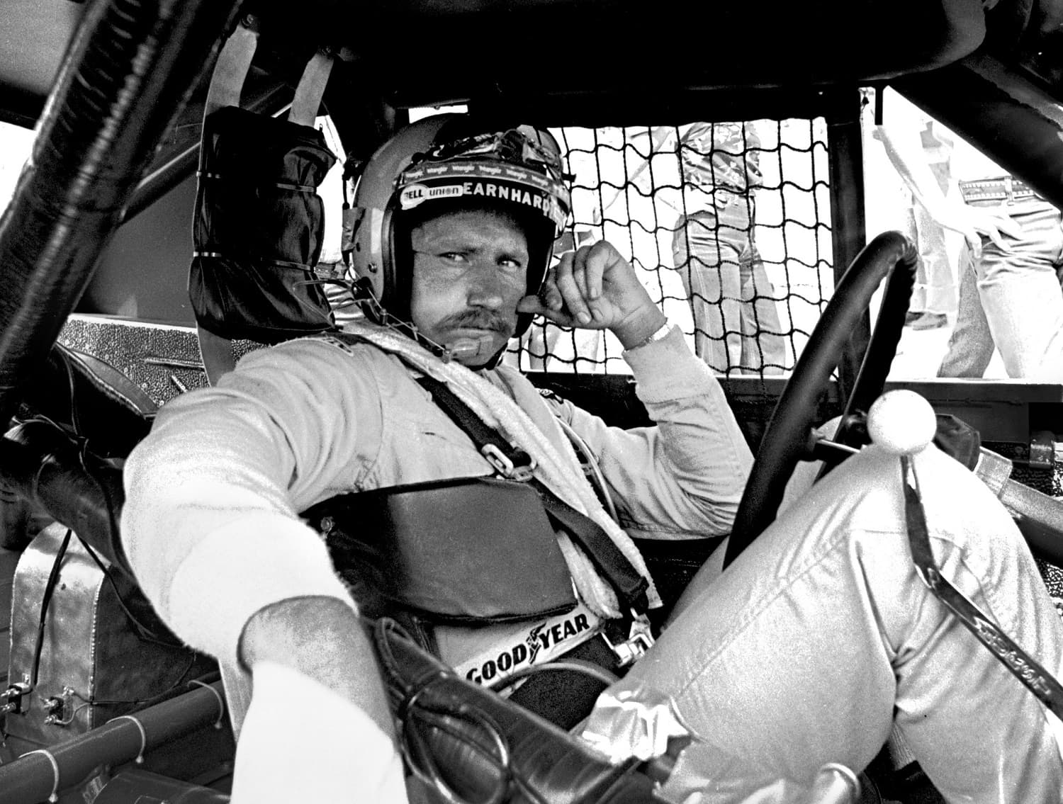 Dale Earnhardt sits in his Pontiac Grand Prix while it is repaired after an accident during the 1981 Firecracker 400 at the Daytona International Speedway on July 4, 1981. | Robert Alexander/Archive Photos/Getty Images