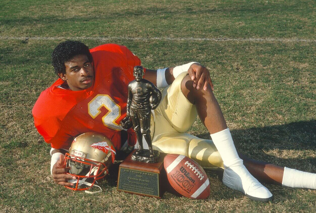 Deion Sanders poses with the Jim Thorpe Award in 1988