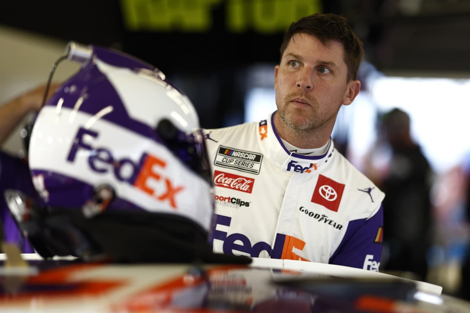 Denny Hamlin looks on in the garage area during practice for the NASCAR Cup Series Daytona 500 on Feb. 17, 2023.