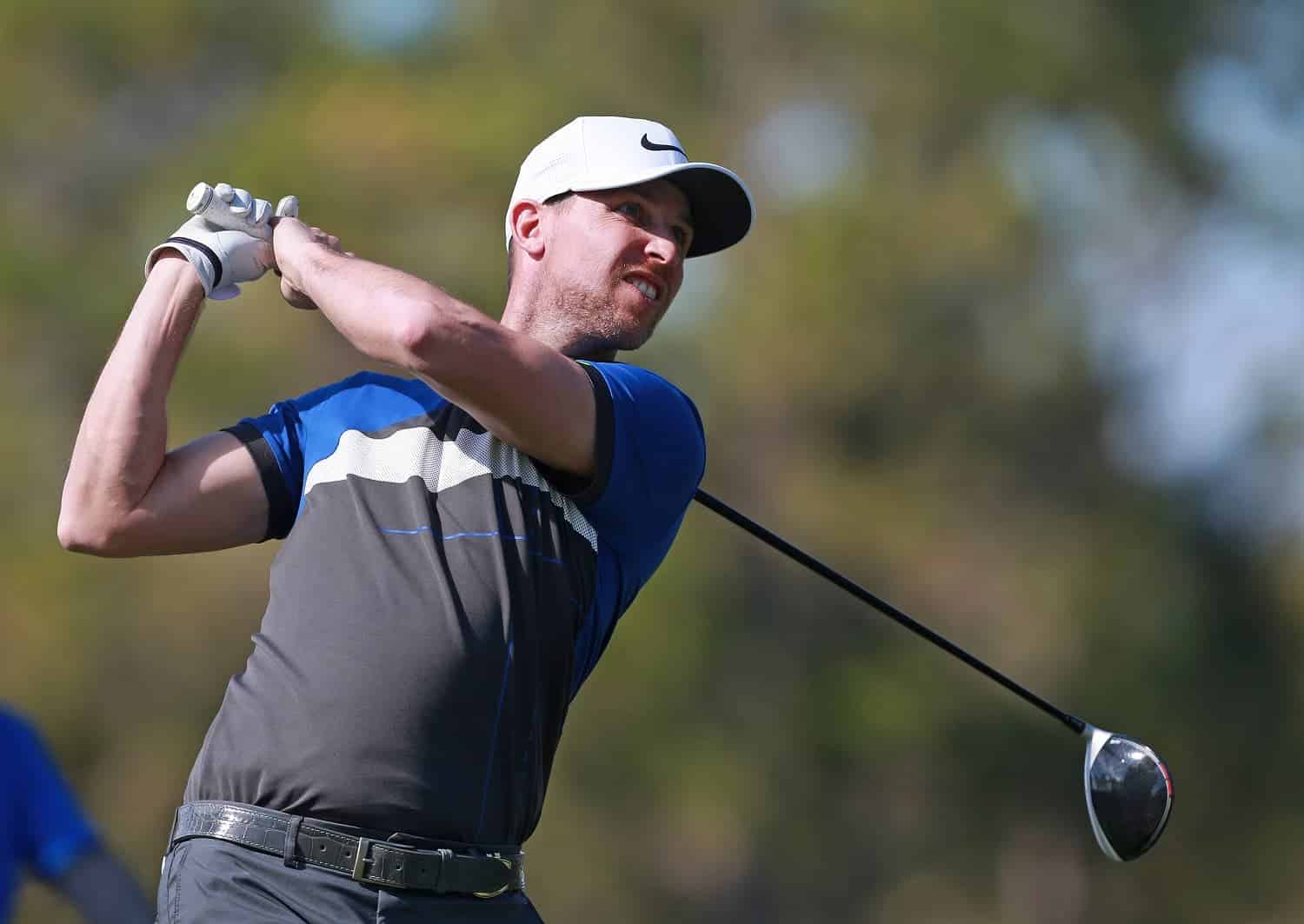 NASCAR driver Denny Hamlin watches his tee shot during the first round of the Diamond Resorts Tournament of Champions at Tranquilo Golf Course at Four Seasons Golf and Sports Club Orlando on Jan. 17, 2019, in Lake Buena Vista, Florida.