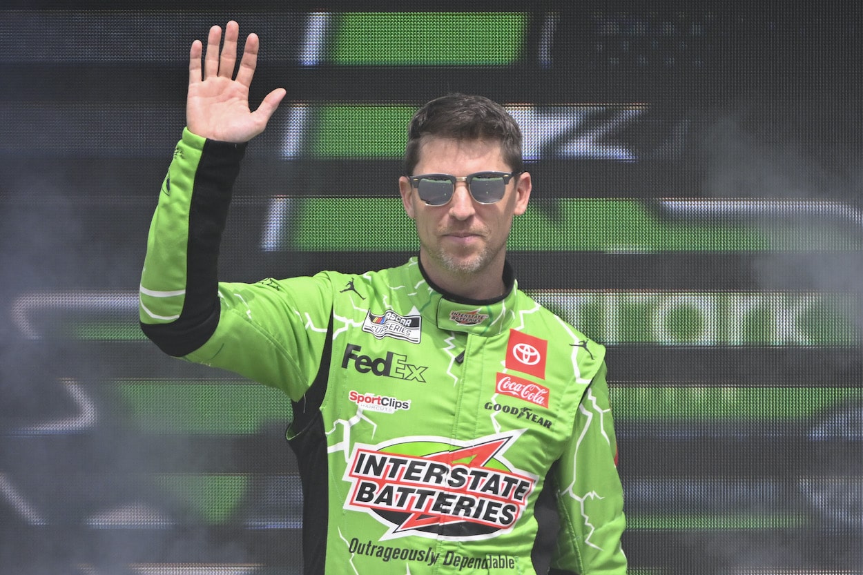 Denny Hamlin waves to fans.