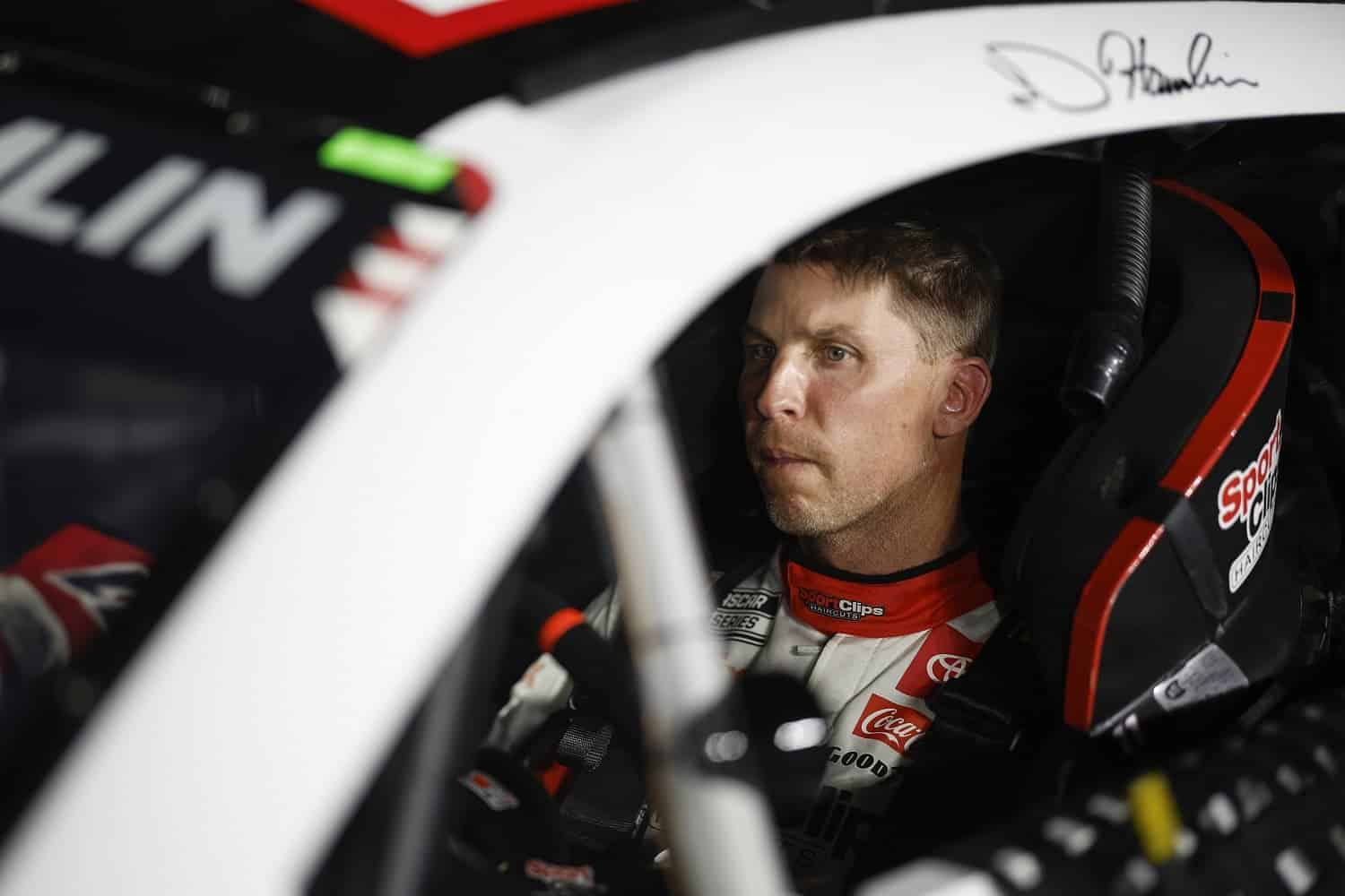 Denny Hamlin sits in his car during qualifying for the NASCAR Clash at the Coliseum at Los Angeles Coliseum on Feb. 4, 2023.